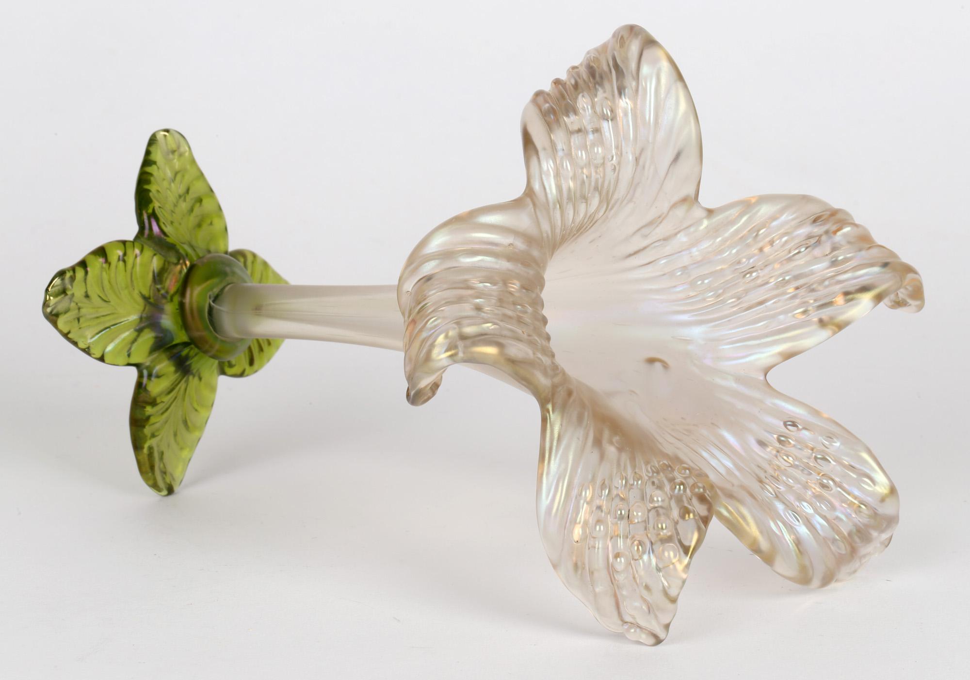 An unusual and scarce Bohemian Art Nouveau iridescent solifleur glass flower shaped vase attributed to Wilhelm Kralik Sohne and dating from around 1900. The finely made vase stands raised on a four leaf shaped foot in green iridescent glass with a