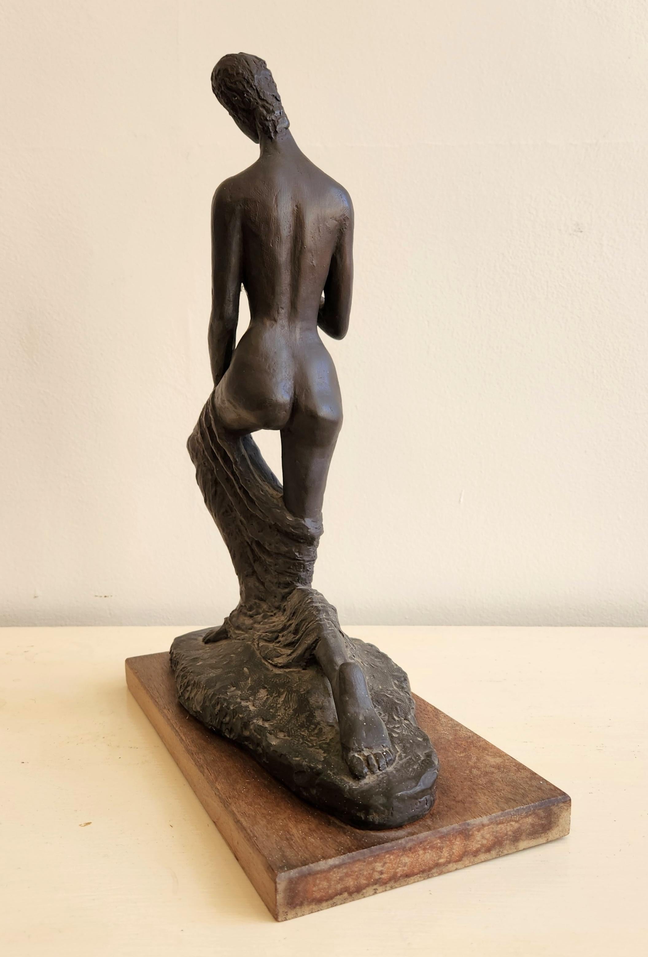 This sculpture is a small replica of Wilhelm Lehmbuck's Kneeling Woman. The original sculpture is much larger at around 69.5 x 56 x 27