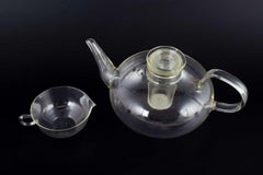 Wilhelm Wagenfeld for Jenaer Glas. Teapot with strainer and creamer, 1930s.