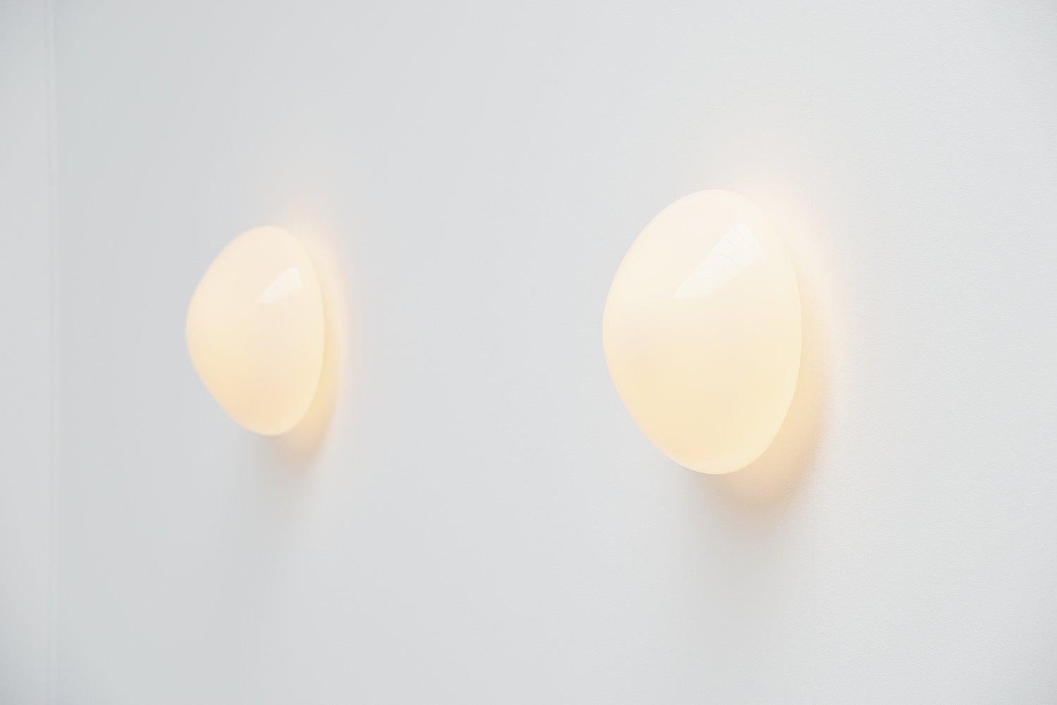 Very nice wall or ceiling lamps designed by Wilhelm Wagenfeld for Lindner, Germany 1955. These lamps have a very nice organic mushroom shape. The ceiling plate is made of solid porcelain and the shade is made of white glass. The lamps give very nice