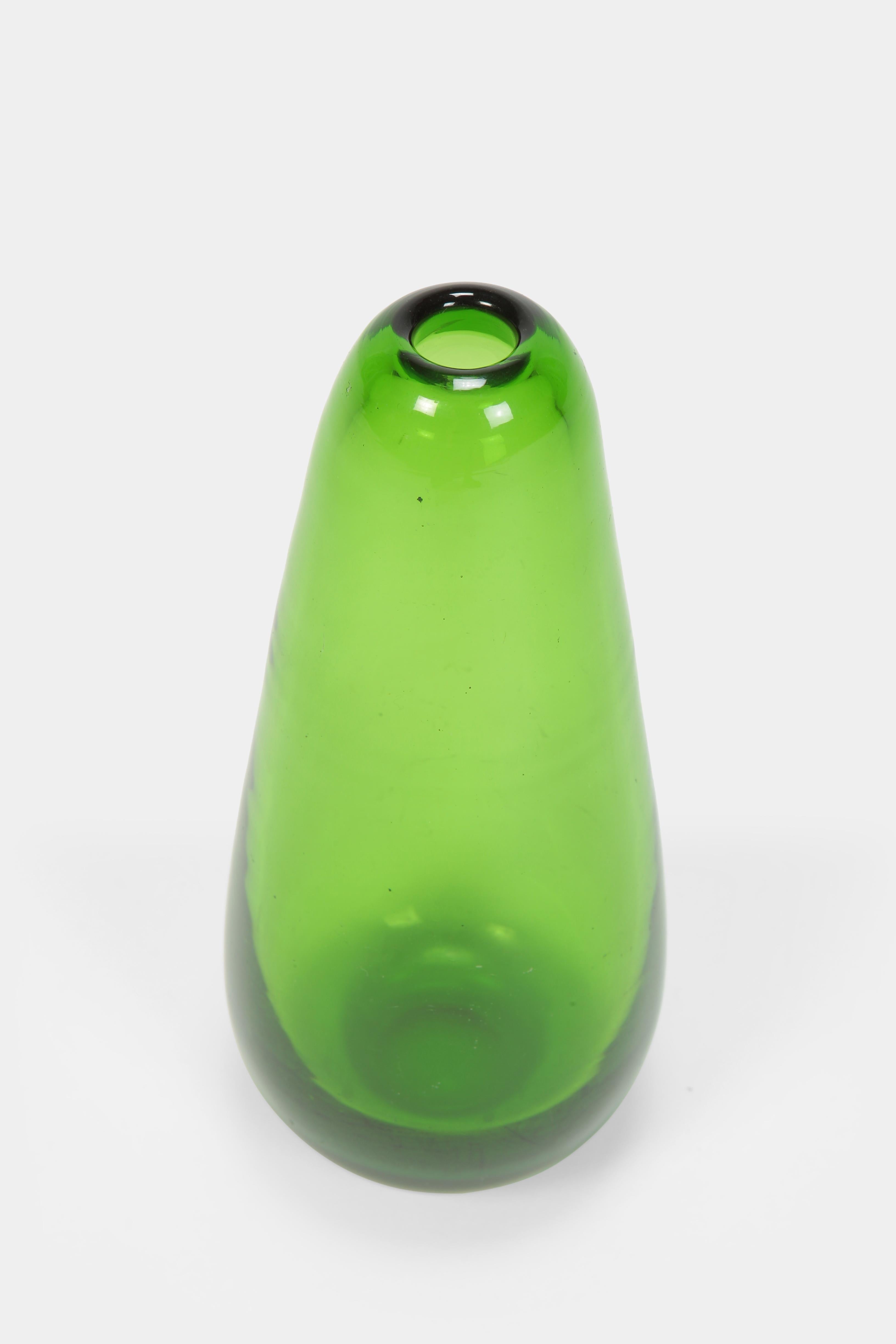 Beautiful Wilhelm Wagenfeld vase manufactured by Jena Glass in the 1950s in Germany. Thick-walled vase made of green glass.