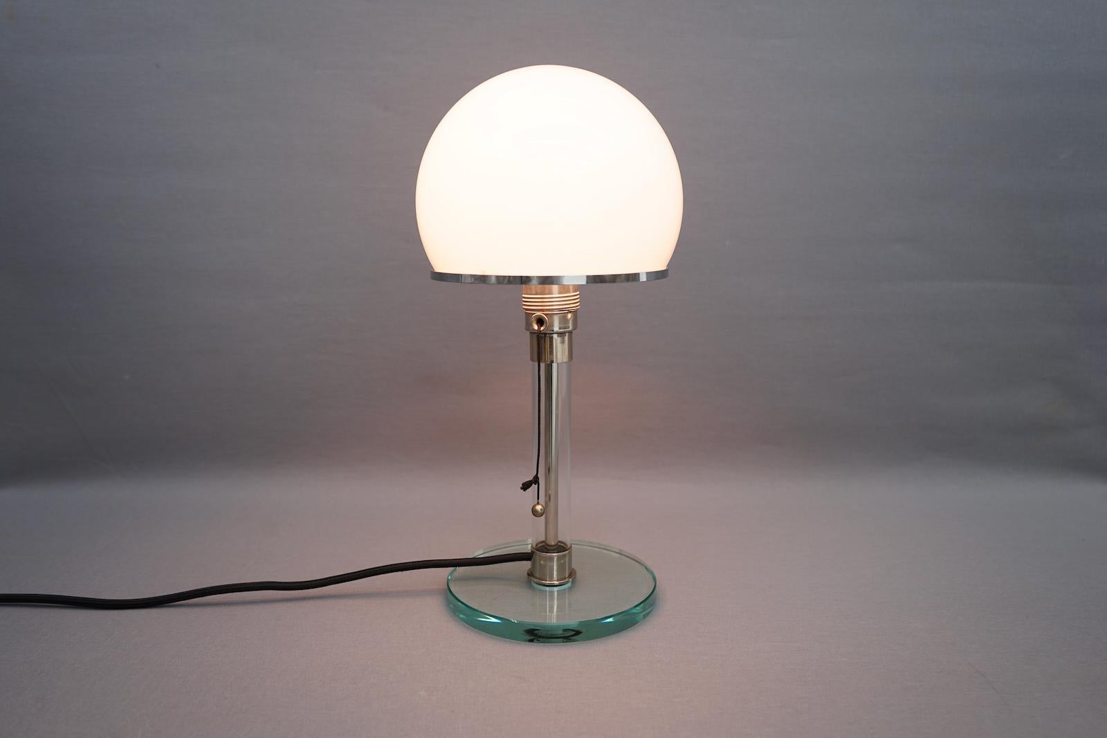 Wilhelm Wagenfeld table lamp WG 24 made of glass. The lamp comes from an early reproduction of Tecnolumen in the 80s. 
Design Wilhelm Wagenfeld, Germany 1924.