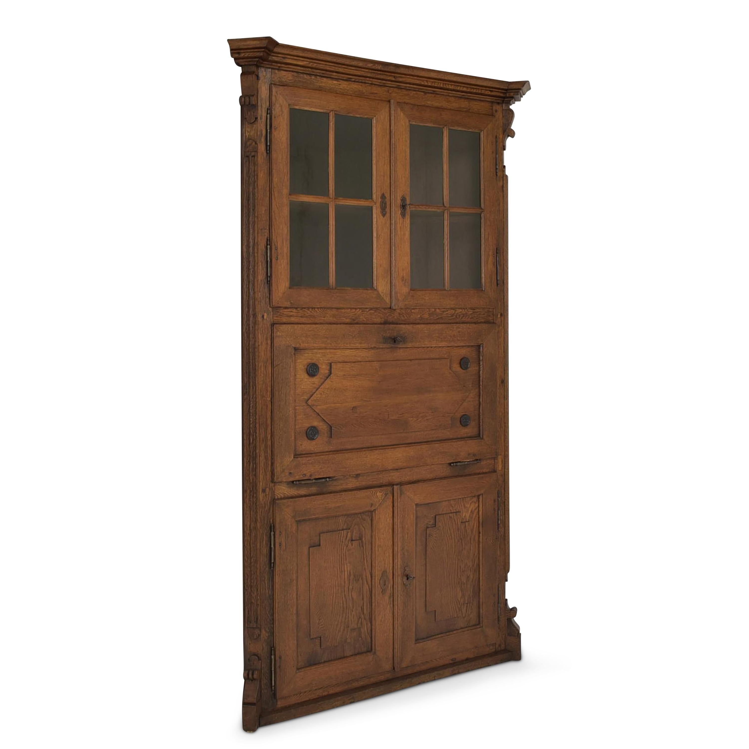 Corner cupboard restored Wilhelminian period around 1870 oak corner display cabinet secretary

Features:
Triple divided with 2 times 2 doors and a folding compartment
Heavy quality
High quality
Original glazing
Very nice patina
Attractive