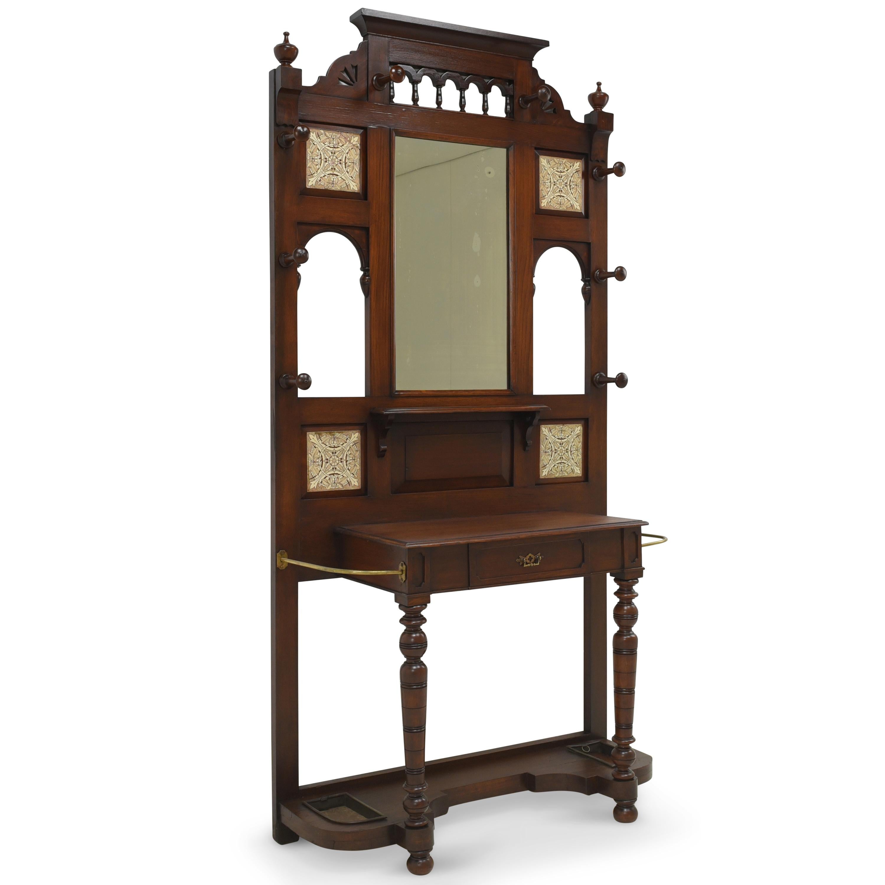 Wardrobe restored Wilhelminian period around 1900 solid oak England

Features:
Model with drawer compartment, umbrella stand, mirror and wooden hook
Originally from England
Beautiful shape
Four ornamental tiles, one damaged
Beautiful