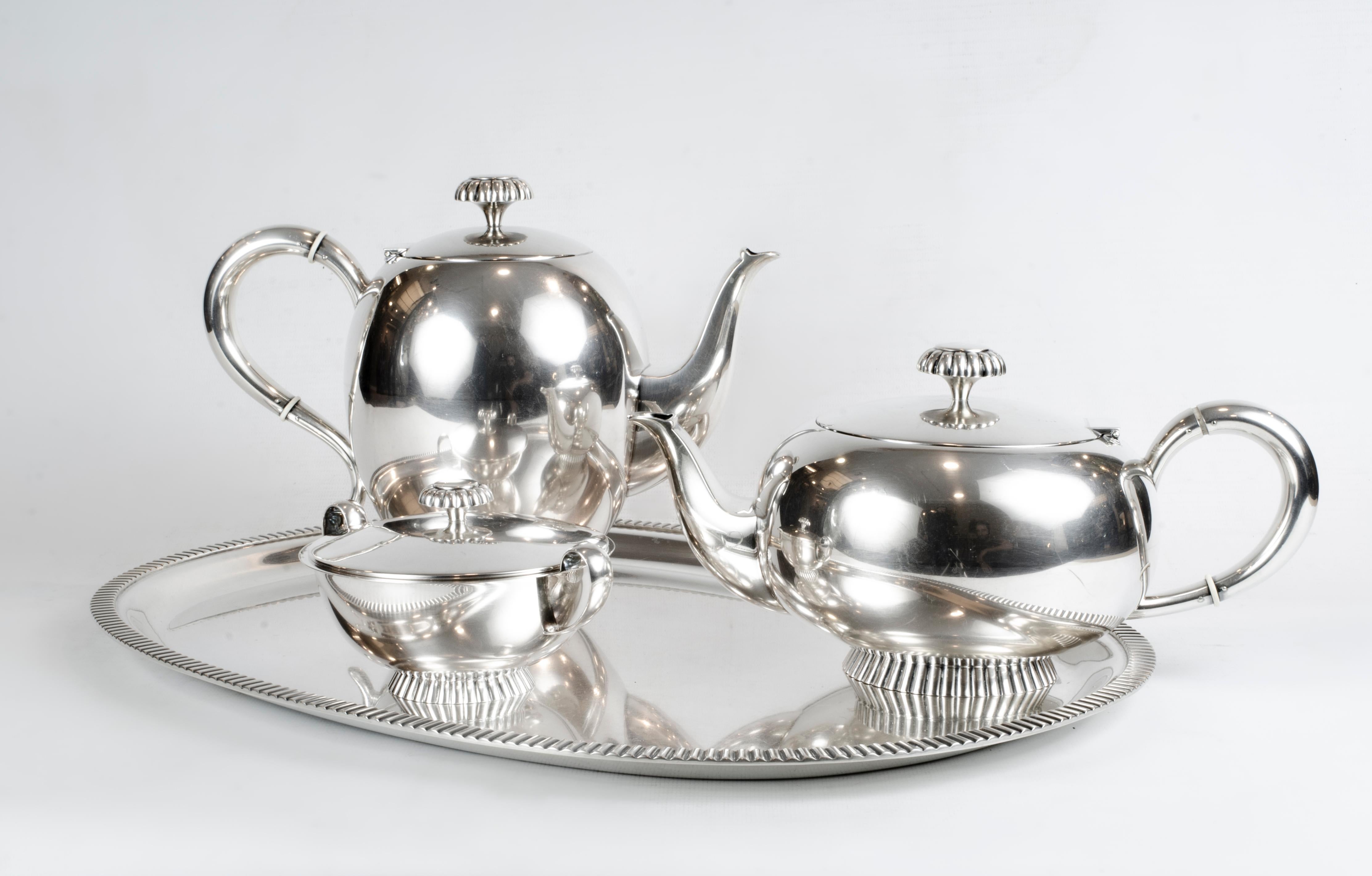 Sterling silver tea and coffee service.
Made by M.H. Wilkens & Sӧhne in Bremen-Hemelingen, Germany. 

The service comprises: 1 coffeepot with hinged cover, 1 teapot with hinged cover, 1 sugar with cover, all on tray.

Hollowware: Coffeepot: ovoid