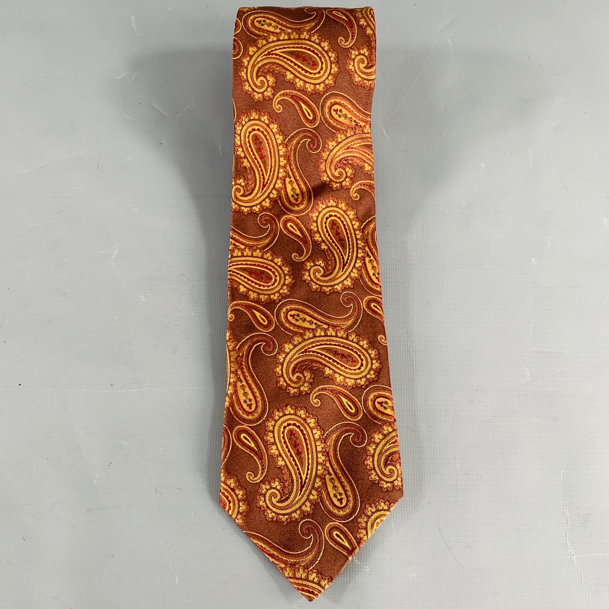 WILKES BASHFORD necktie
in a brown and orange silk featuring a paisley jacquard pattern. Handmade in Italy.Very Good Pre-Owned Condition. 

Measurements: 
  Width: 3.5 inches Length: 63 inches 
  
  
 
Sui Generis Reference: 135869
Category:
