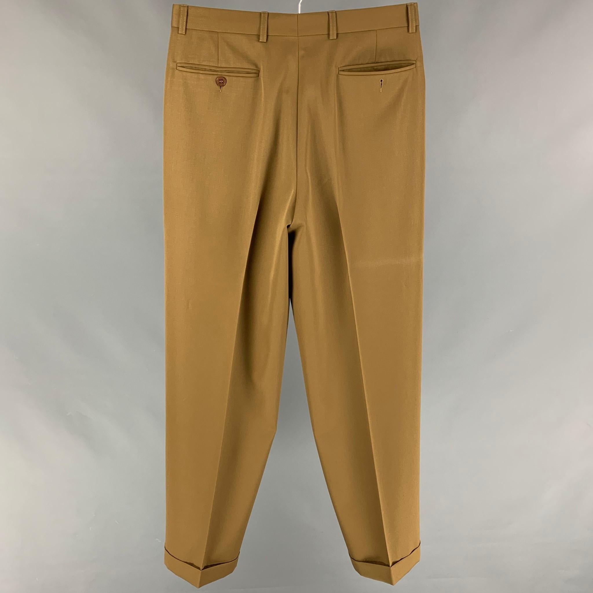WILKES BASHFORD dress pants comes in a khaki wool featuring a front pleated style, relaxed fit, cuffed leg, and a zip fly closure. 

Very Good Pre-Owned Condition.
Marked: Size tag removed.

Measurements:

Waist: 31 in.
Rise: 12 in.
Inseam: 31 in. 