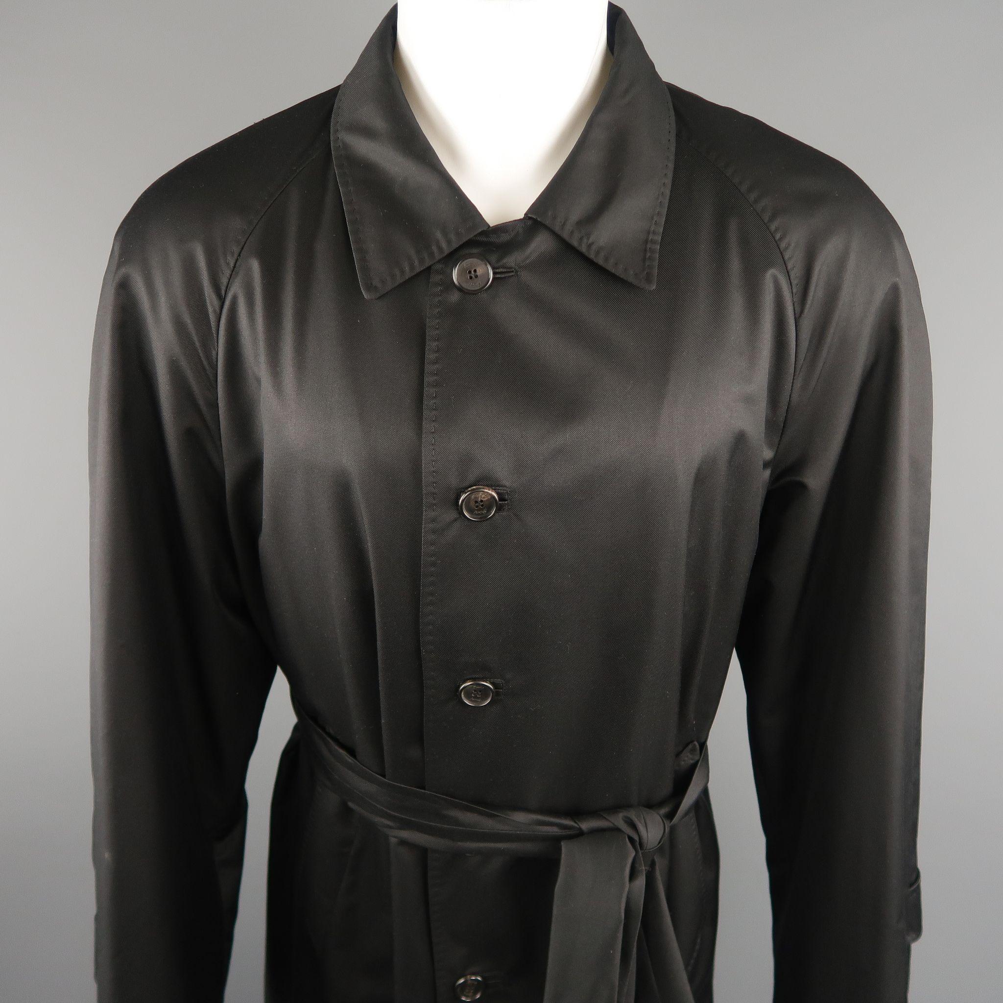 WILKES BASHFORD tailored by BRIONI long trench coat comes in a black solid silk, with slit pockets, leather button holes, brioni lining, back vent and belt. Made in Italy. 

Excellent Pre-Owned Condition.
Marked: 48 US

Measurements:

Shoulder: 17.5