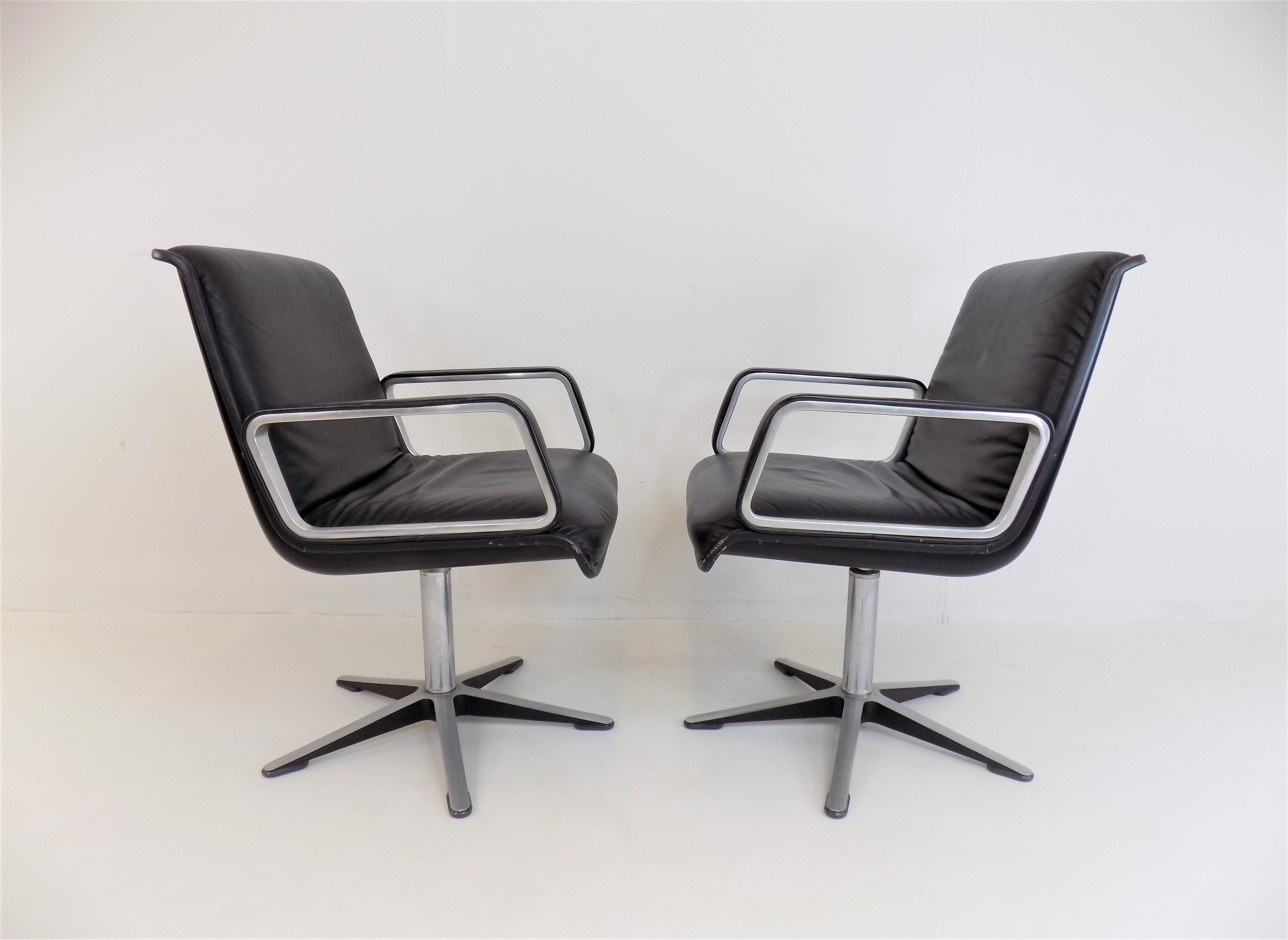 A set of 2 late generation Wilkhahn Delta leather armchairs, with fully leather clad brushed aluminum armrests and black back shells, which is in superb condition. The leather is flawless, the plastic shells and the aluminum feet only have slight