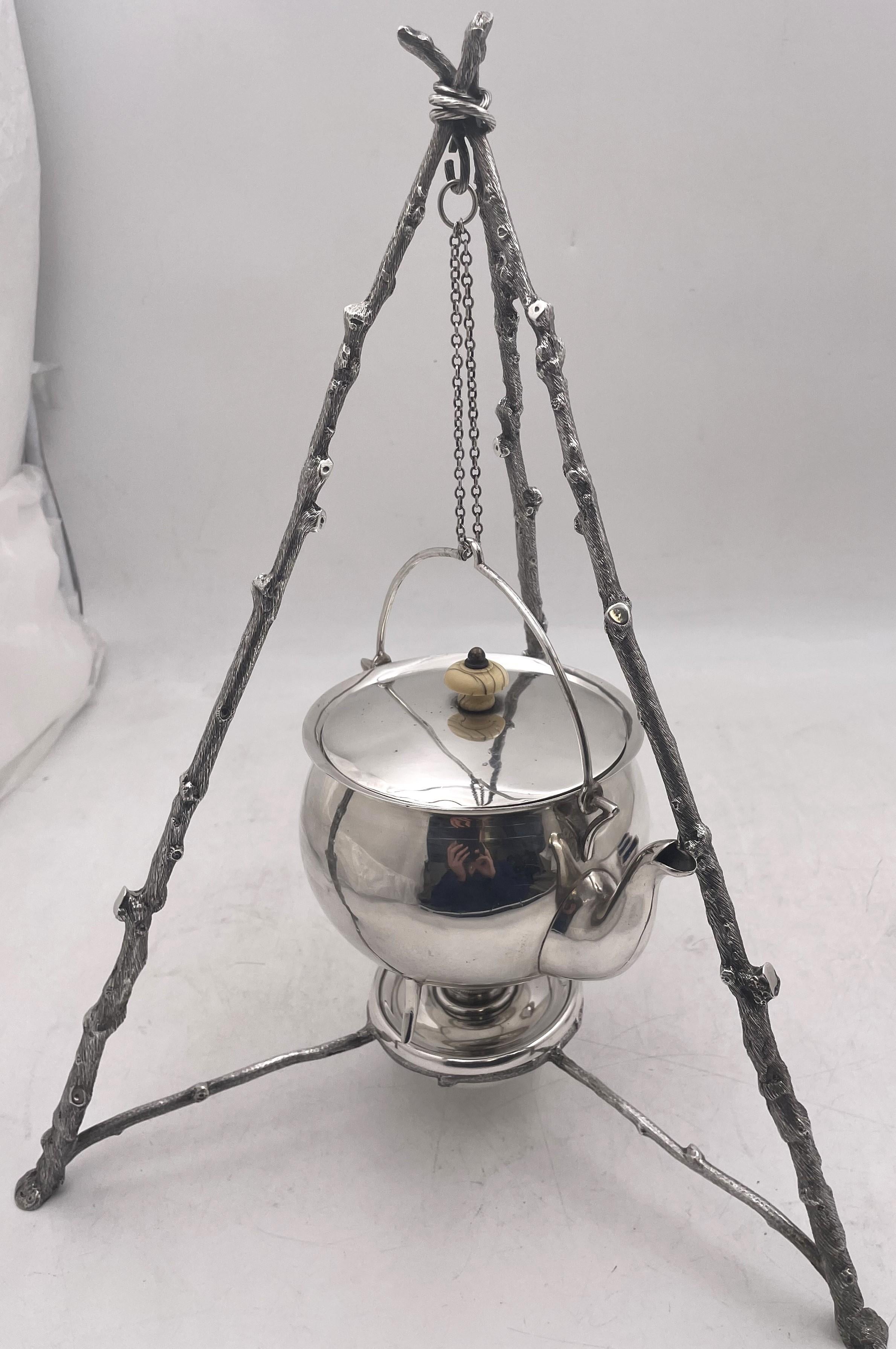 Wilkinson rare and novel sterling silver teapot on stand from 1871 (Victorian era), in the style of Christopher Dresser, consisting of:

- a finely engraved stand measuring 16'' in height by 11'' in width from leg to leg
- a burner
- a teapot