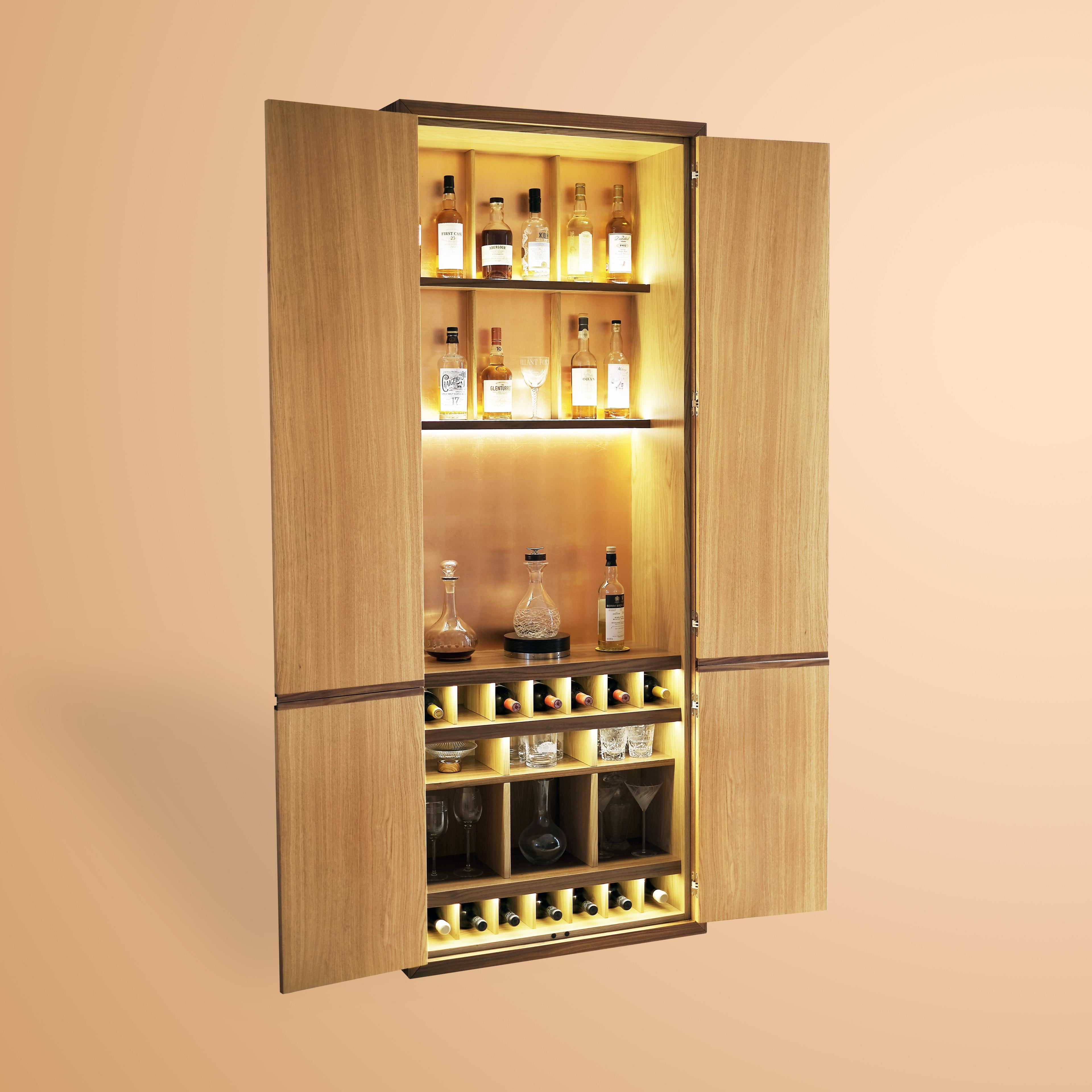 Four doors drinks cabinet with antique mirror on the top and burr oak at the bottom.
Interior in oak veneer, walnut details and copper leaf at the back.

As with all our furniture, this drinks cabinet is made to order and is therefore highly