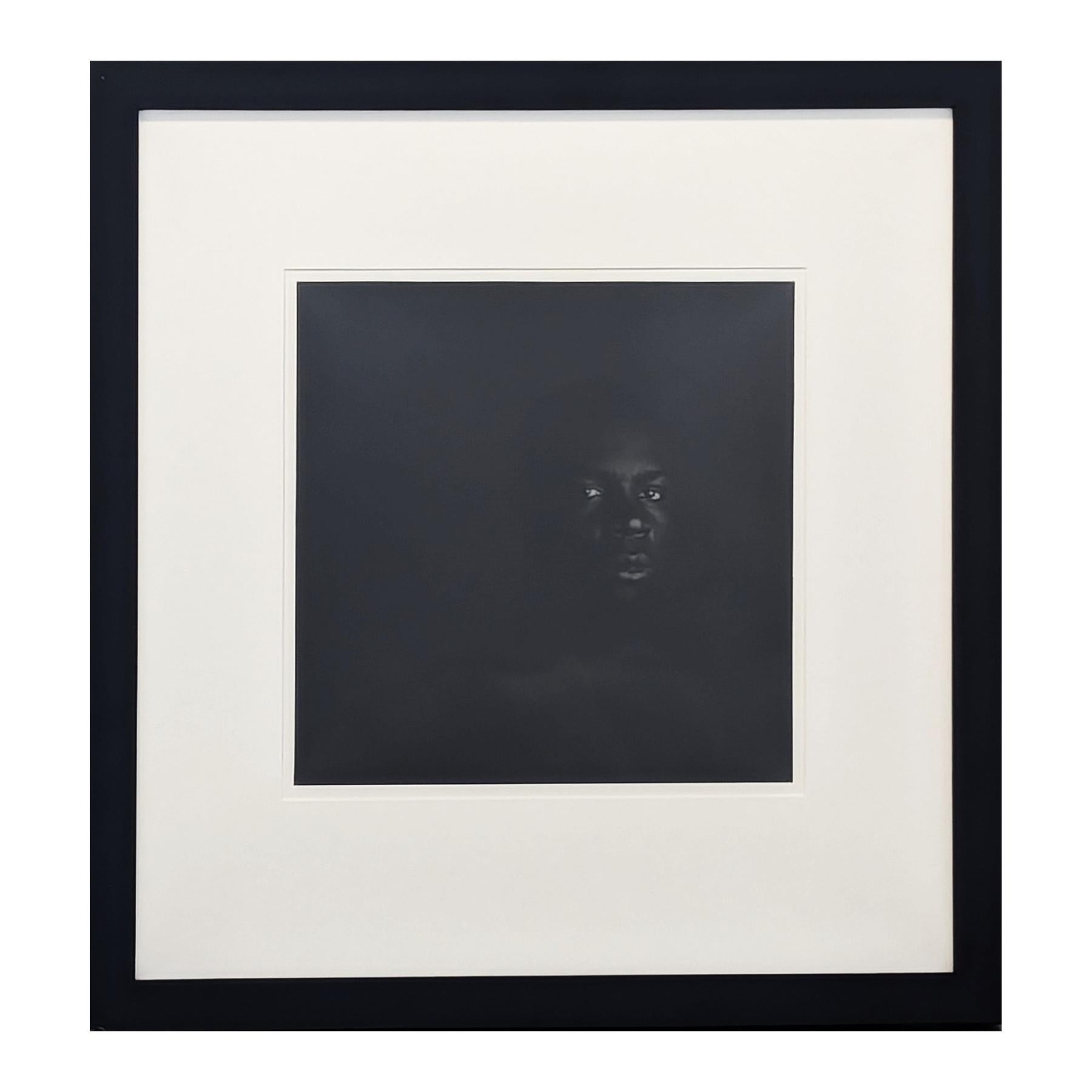 Contemporary black and white figurative photograph by artist Will Michaels. The piece features a black man set against a dark background. Currently hung in a black frame with a white matting.

Dimensions Without Frame: H: 12.5 x W: 12.5