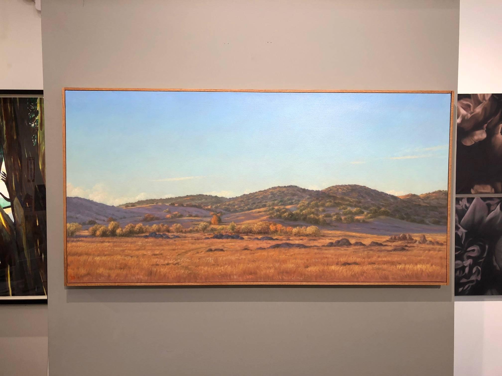 Going to Borrego oil painting, contemporary landscape  — in blue, orange, purple, green. Early morning warm western rolling hills with clear sky. 24 x 48 inches. 

One of our finest American contemporary realist painters, Willard Dixon has painted