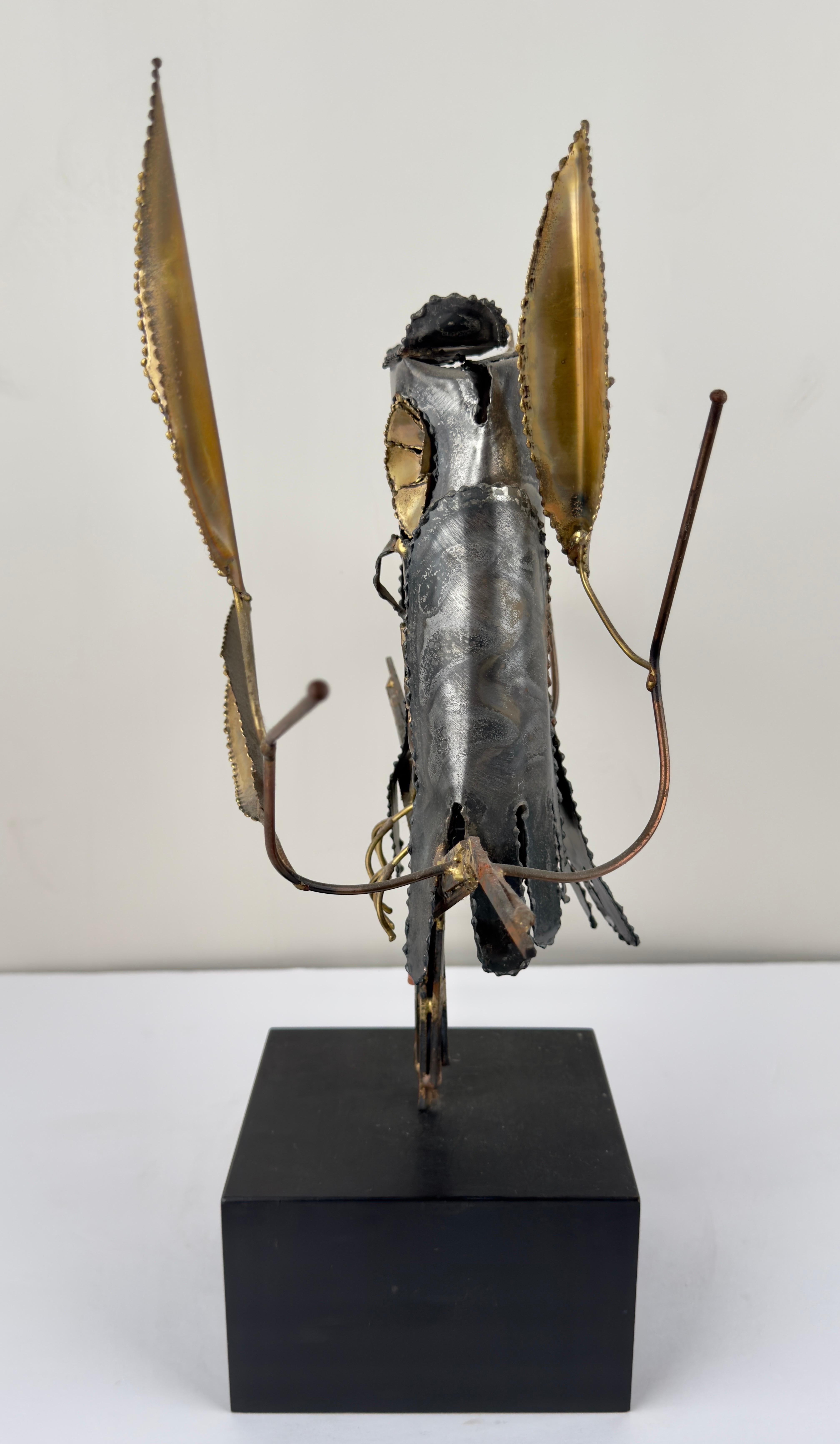 A brutalist Mid- Century Modern sculpture of an owl by Willem DeGroot ( Netherlands, 20th Century ).  The sculpture is made of brass and metal and showing an owl stating on a branch with brass leaves. The sculpture is raised but an acquire black