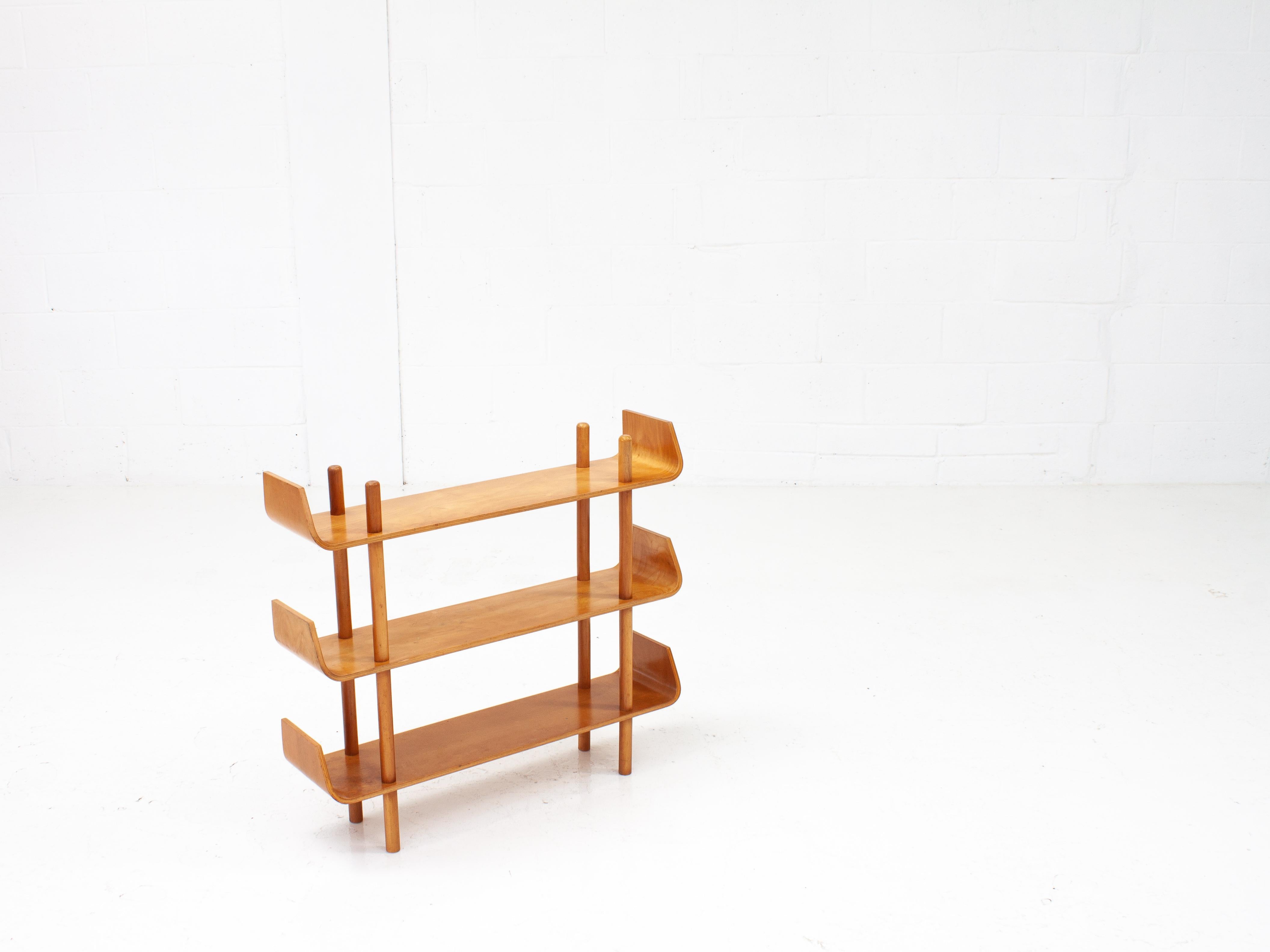 A plywood shelving unit by Willem Lutjens for De Boer Gouda, with the characteristic curved ends of the shelves which has made this such a famous and now rare design. The piece was designed in 1953 and manufactured in the Netherlands.

The