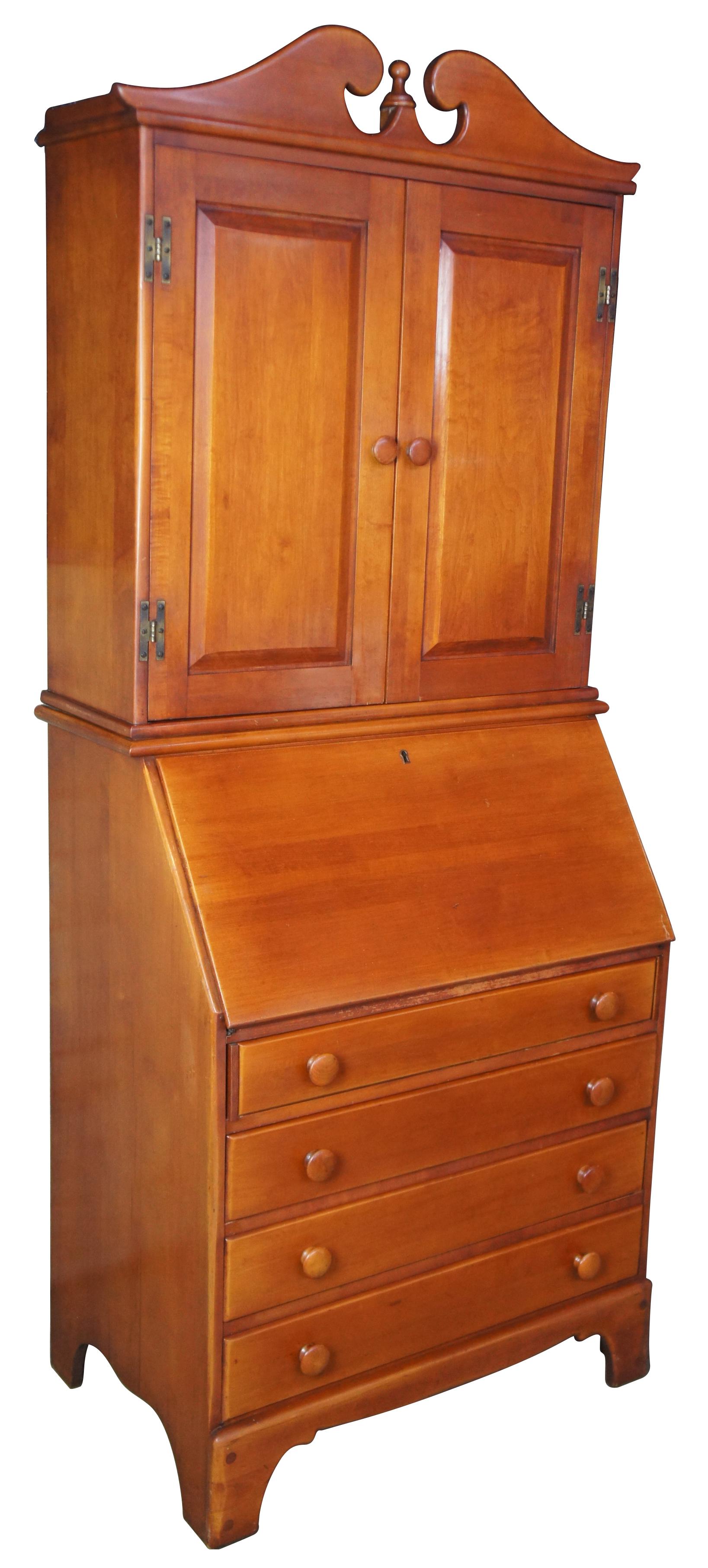 Mid-20th century secretary with bookcase by H. Willett. Part of the Golden Beryl Maple collection. Features a slant top fold out writing surface, interior compartments for storage, four drawers and upper bookcase with three shelves.
     