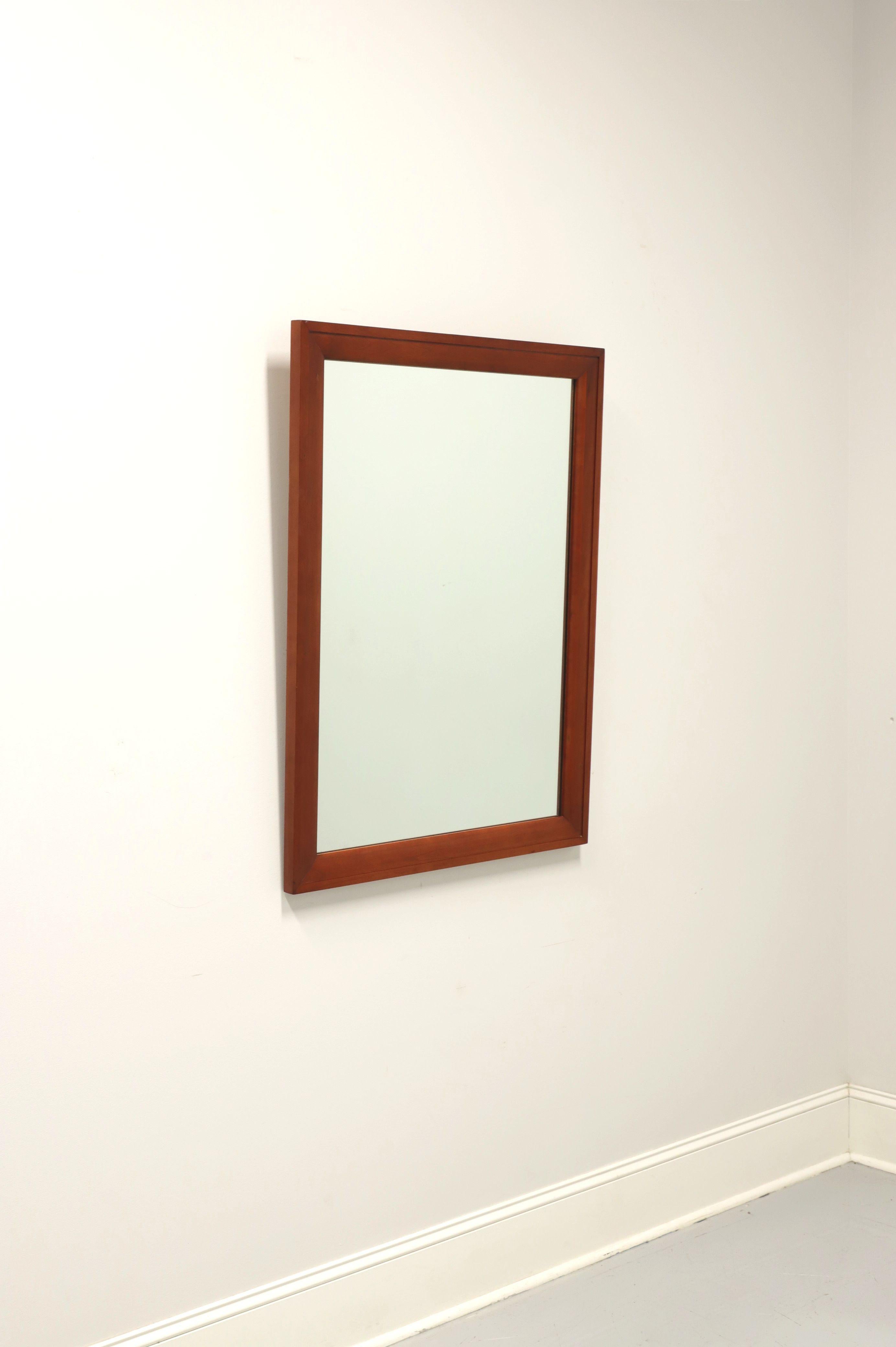 A Mid Century dresser or wall mirror by Willett Furniture, of Louisville, Kentucky, USA. Mirrored glass in a rectangular solid cherry frame. Made in the mid 20th Century.

Measures: 30.25W 1.25D 40.25H, Weighs Approximately: 32 lbs

Exceptionally