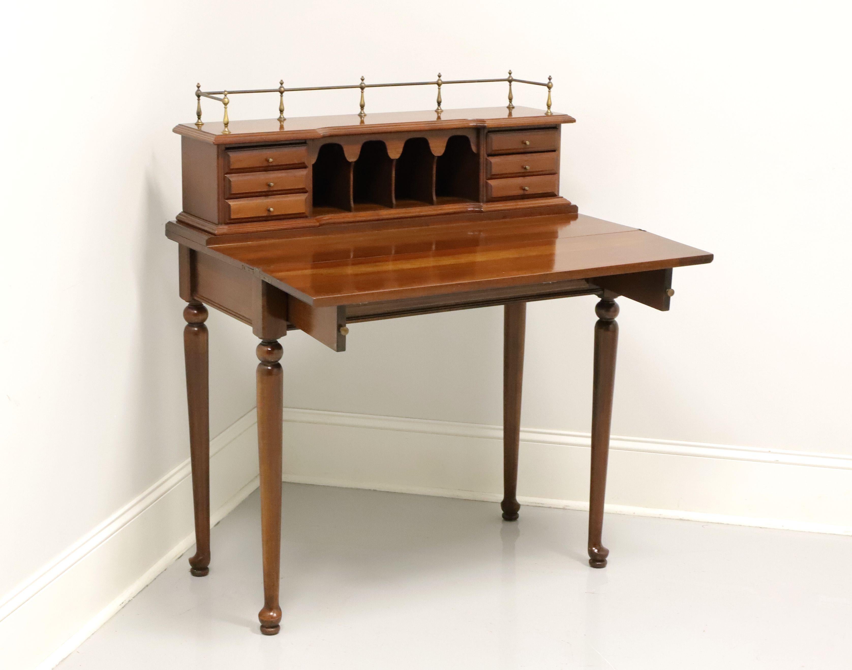 A Chippendale style petite writing desk by Willett Furniture, of Louisville, Kentucky, USA. Solid cherry with brass hardware & gallery, round legs and pad feet. Features an upper area of six smaller drawers & four cubbies with gallery atop, fold out