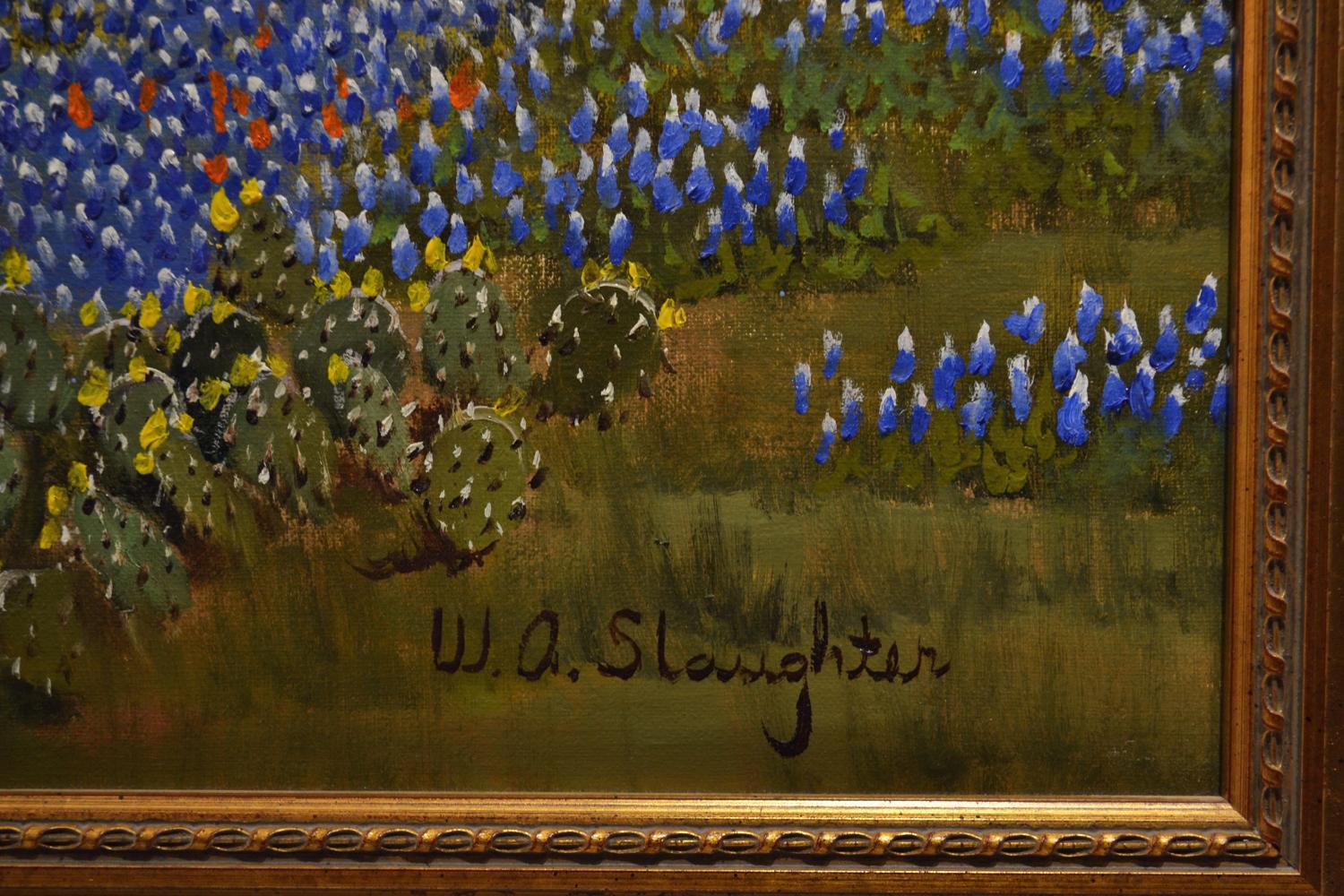 An open rustic landscape dotted with Texas bluebonnets.  Rolling green and blue hills fade into the cloudy sky, and a large tree obscures most of the right side of the frame.  A small stream runs through the center of the frame, while flashes of