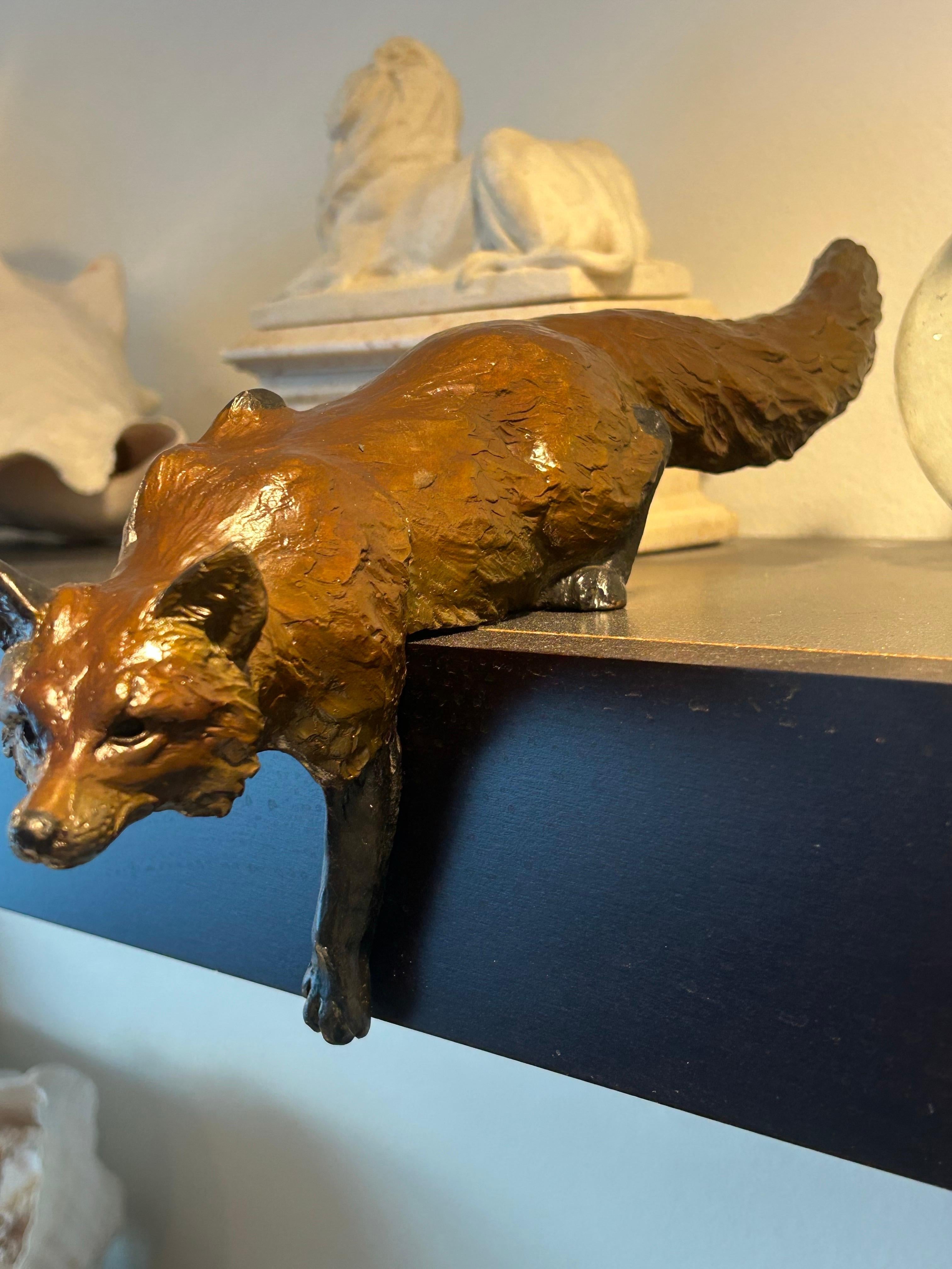 This fox that is stalking on a shelf or standing up by David Turner, the son of William Turner. They are a sculpting, father and son team who make whimsical and detailed bronzes of fox, rabbits, ducks and other objects. We purchased this in a