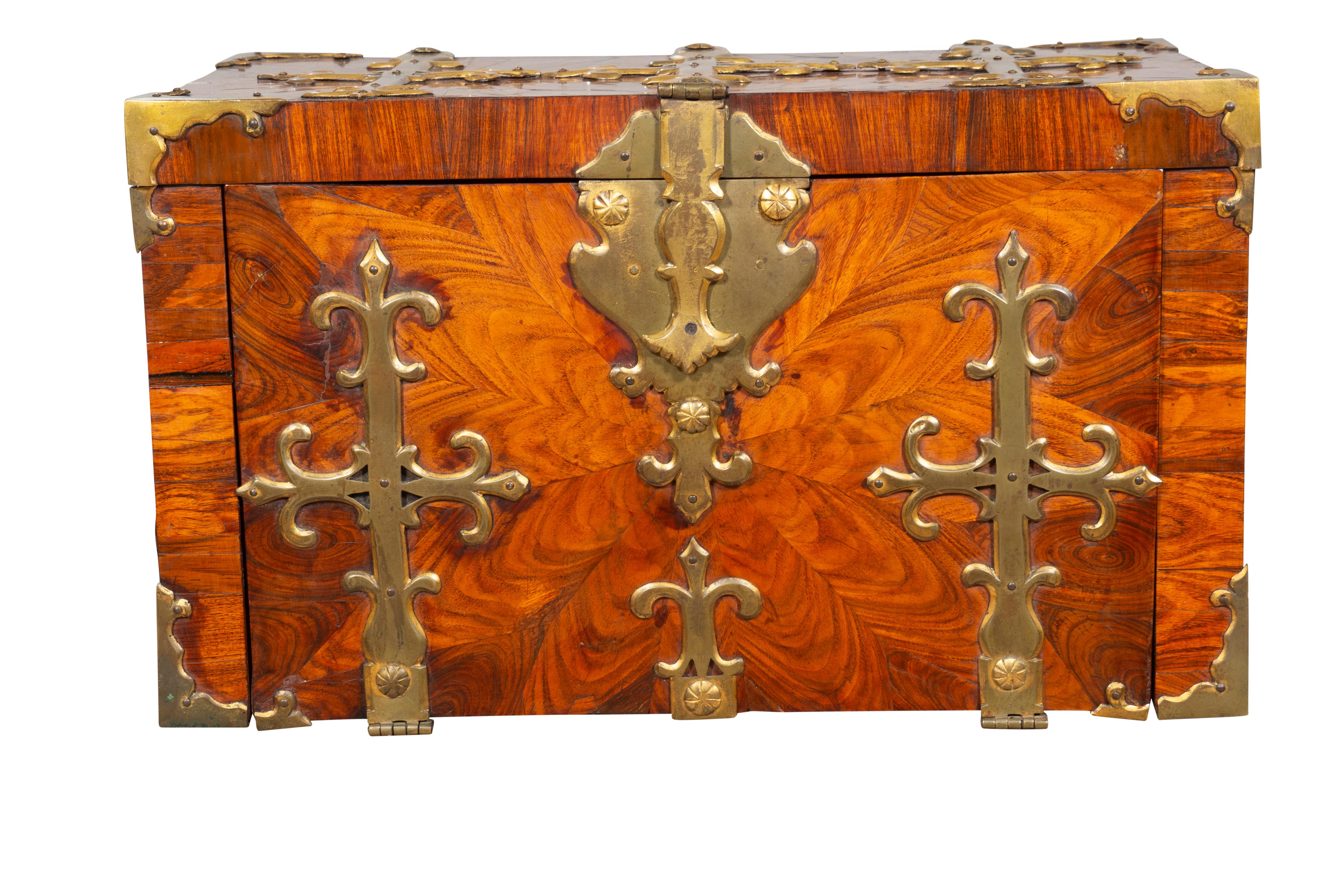 With rectangular hinged top with brass strap mounting. When open the front folds down to expose hidden compartments and wells. Case mounted the same as the lid. Side carry handles. Interesting larger size. These boxes were used to secure valuables.
