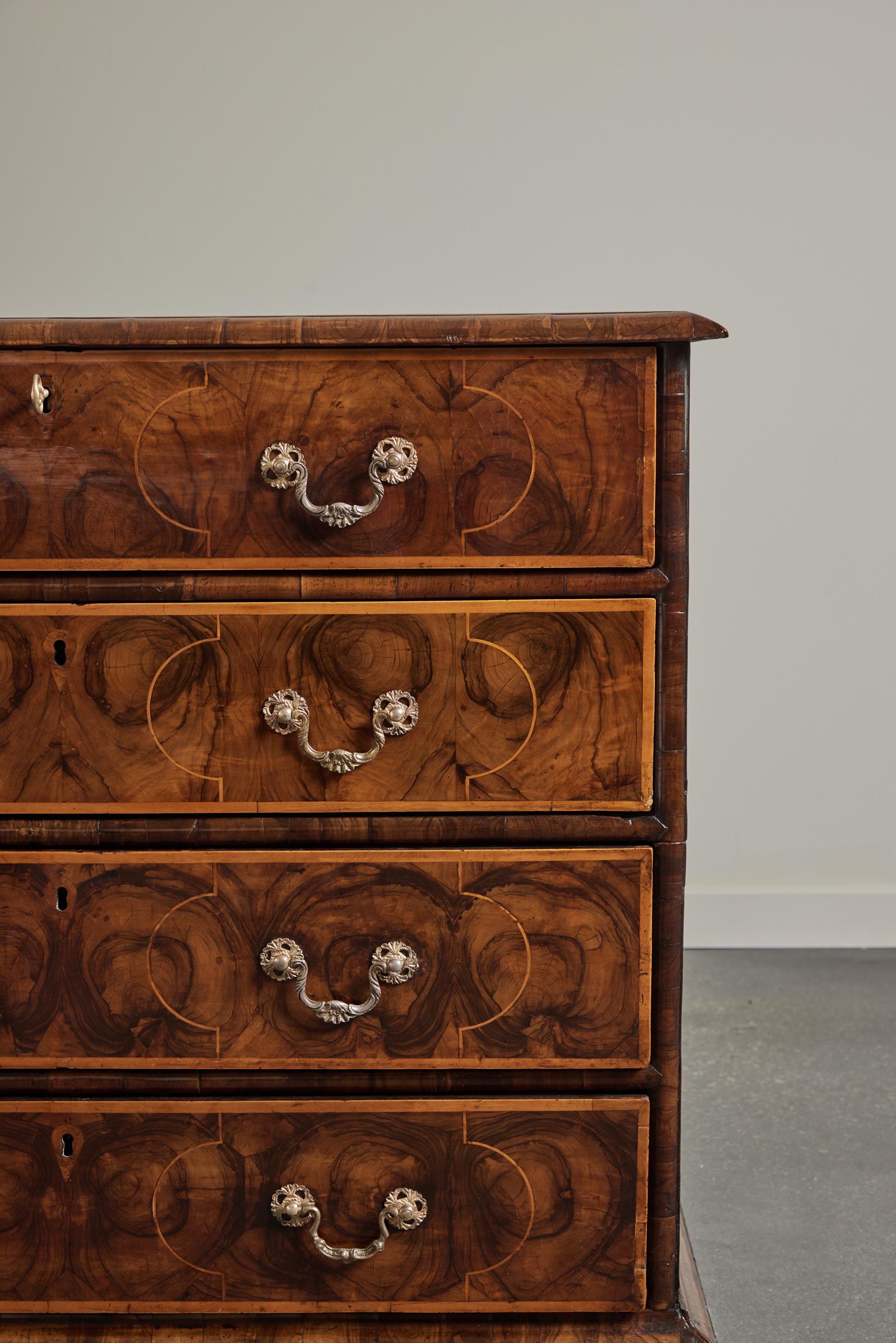 A William and Mary laburnum oyster veneered and line inlaid chest of drawers ca 1690.

The top with well-chosen oyster inlays contained within contrasting line inlaid geometrical patterns above four long graduated drawers all faced with exquisite