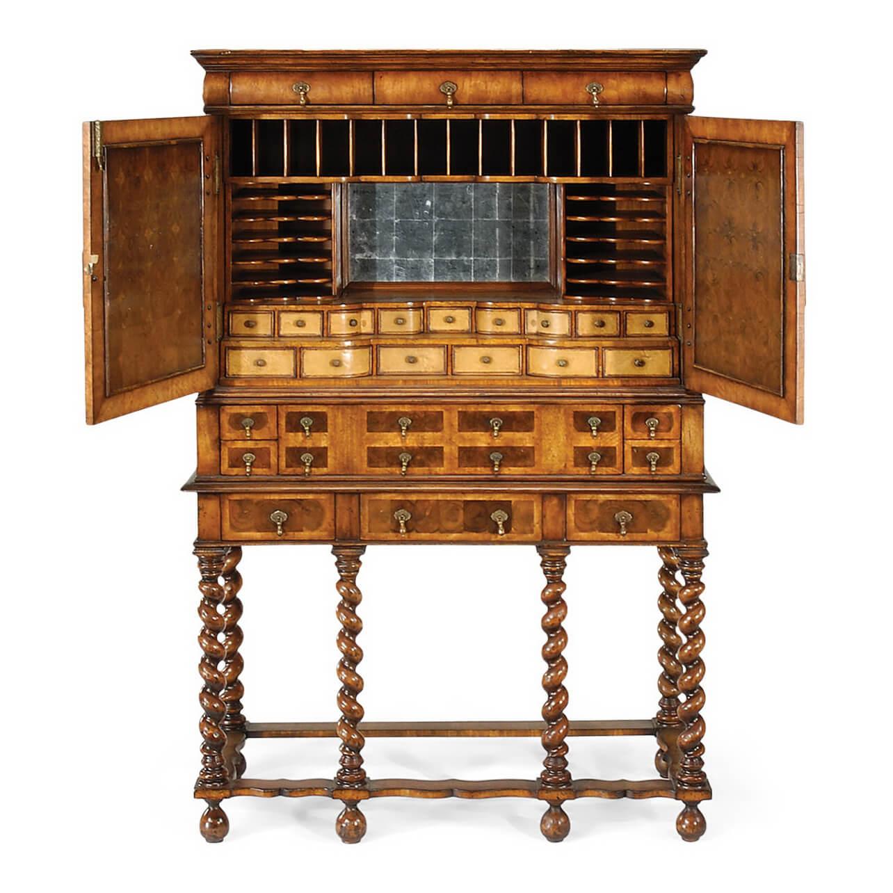 A fine William and Mary style walnut secretaire cabinet with fine oyster veneers to the paneled doors, multiple small drawers to the exterior and fully fitted interior with églomisé lined alcove and shelves, drawers and pigeonholes. The whole raised