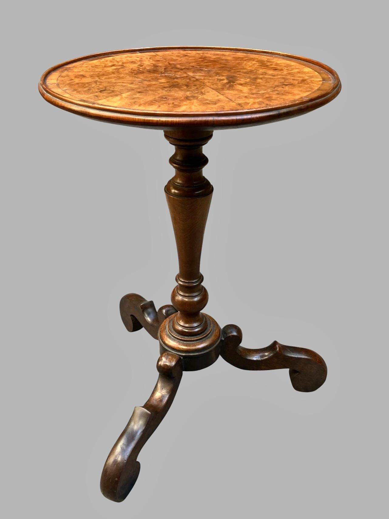 A charming English William and Mary style walnut veneered side table, the top veneered in 6 sections, supported on a turned standard ending in a tripod base. W. Charles Tozer was a well-known English furniture maker from the late 19th century until