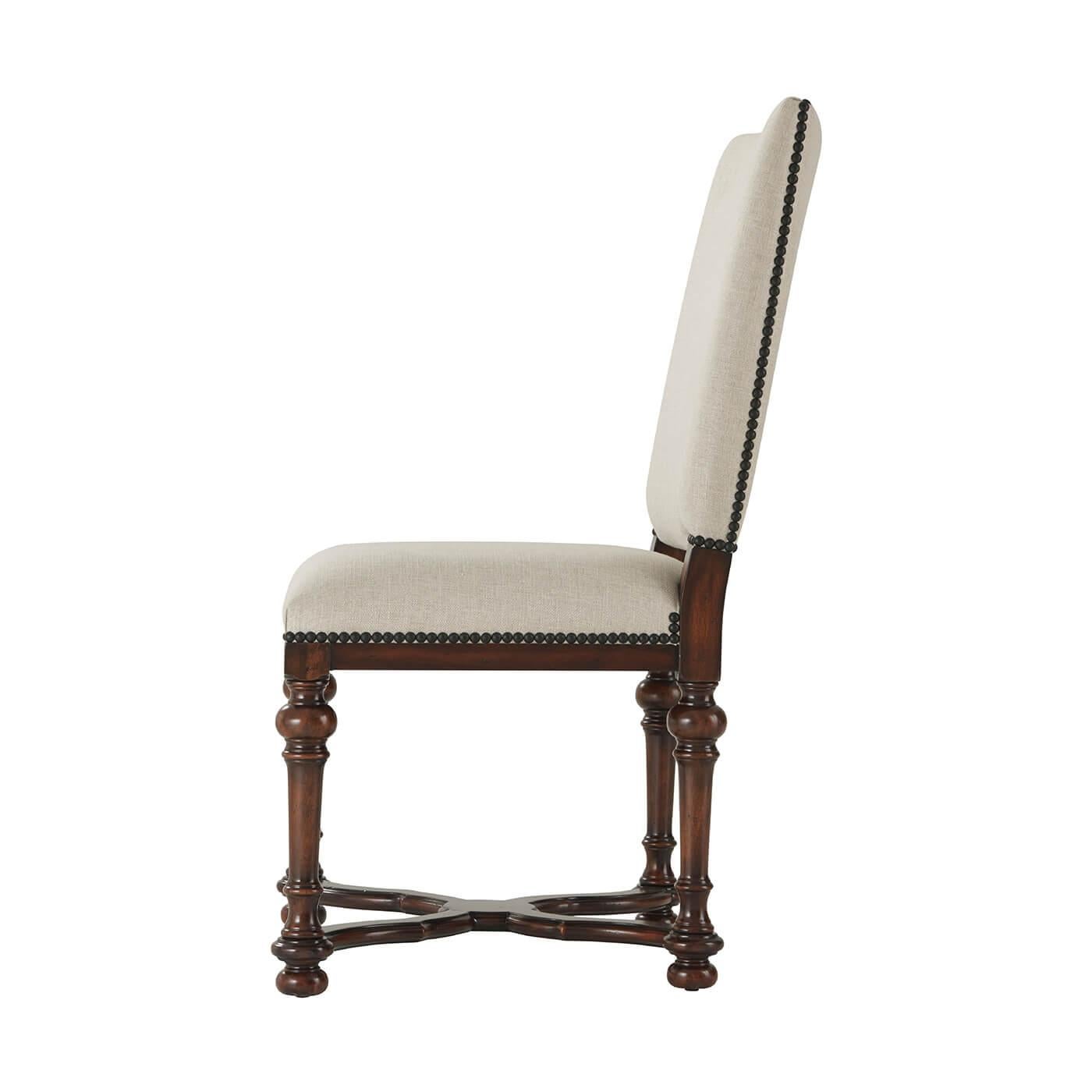 William and Mary style hand-carved dining chair, the rectangular padded back and an upholstered seat on turned tapering legs joined by a wavy 