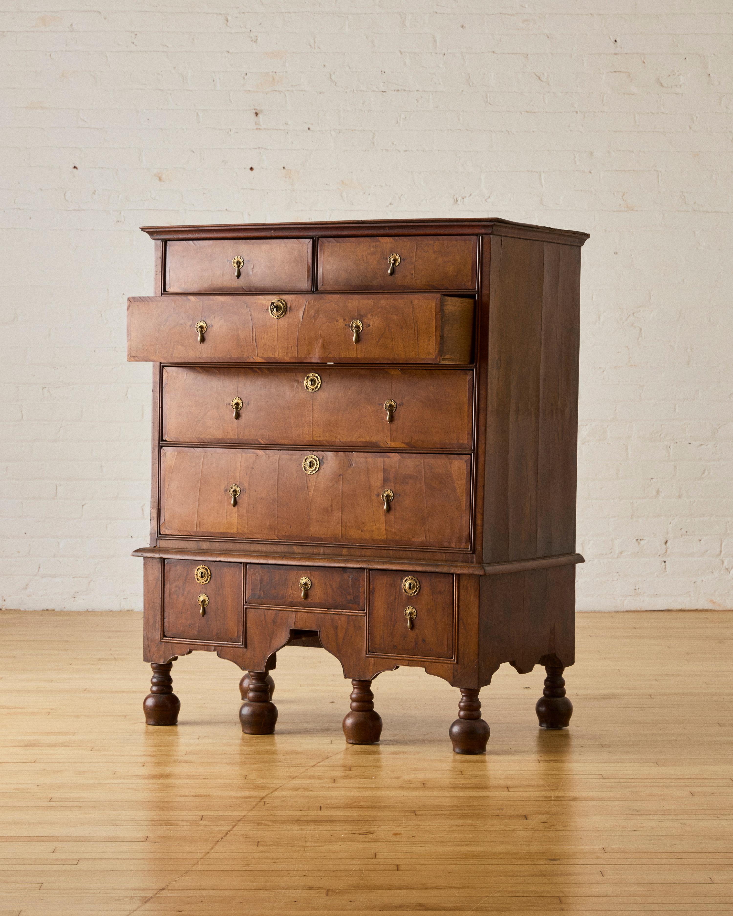 William and Mary Walnut Chest with teardrop feet, scalloped apron, and brass lock and key details, key included.

