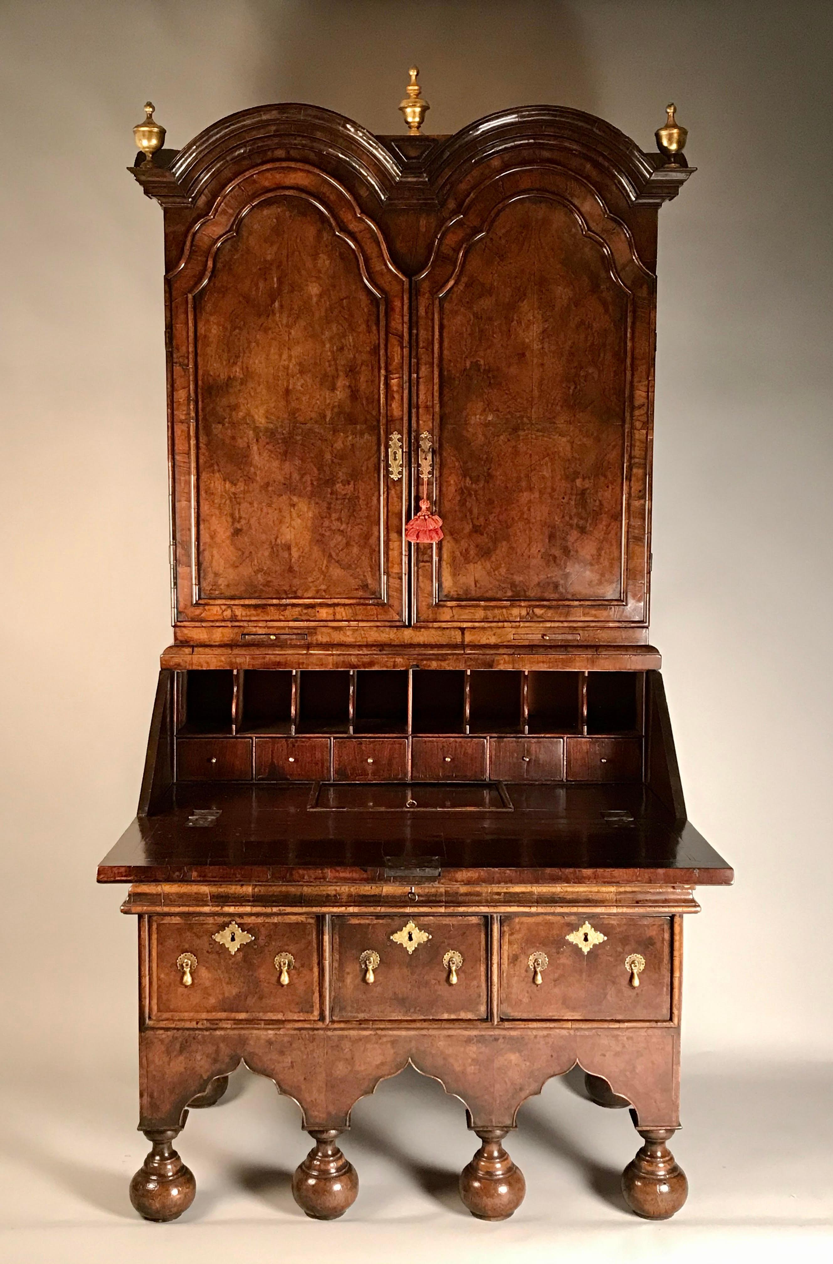 A rare William & Mary period walnut double-dome bureau bookcase / cabinet. Circa 1685.

Of compact size and proportions.
In excellent overall condition with old, waxed, well-patinated surfaces of very good color.

This bureau bookcase, or cabinet,