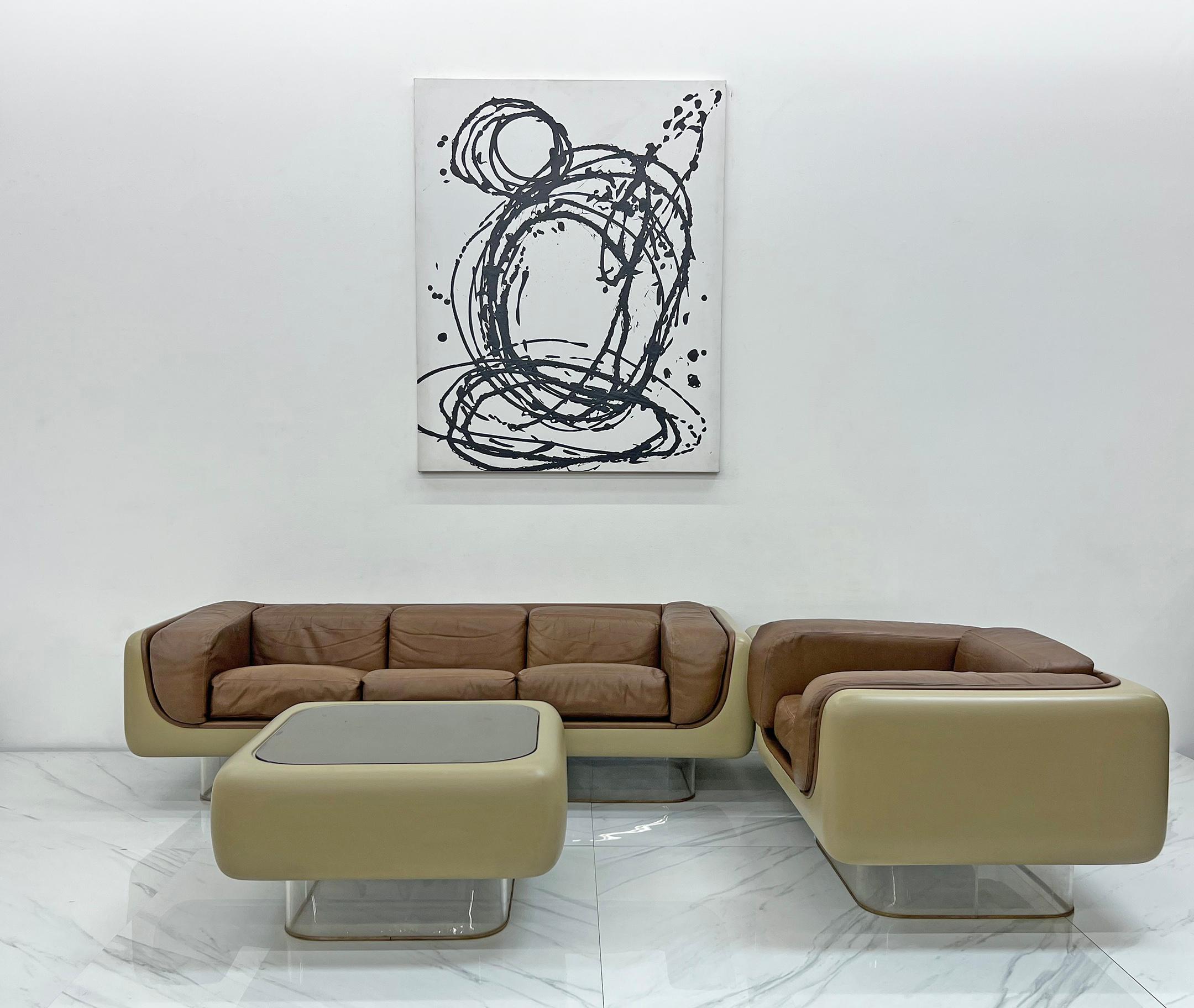 Designed in the 1970's, this living room suite is considered as one of the holy grails for space age and modern design enthusiasts alike. (4 pieces, Large #465 Soft seat sofa, lounge chair, coffee table and matching side table) .With its curved