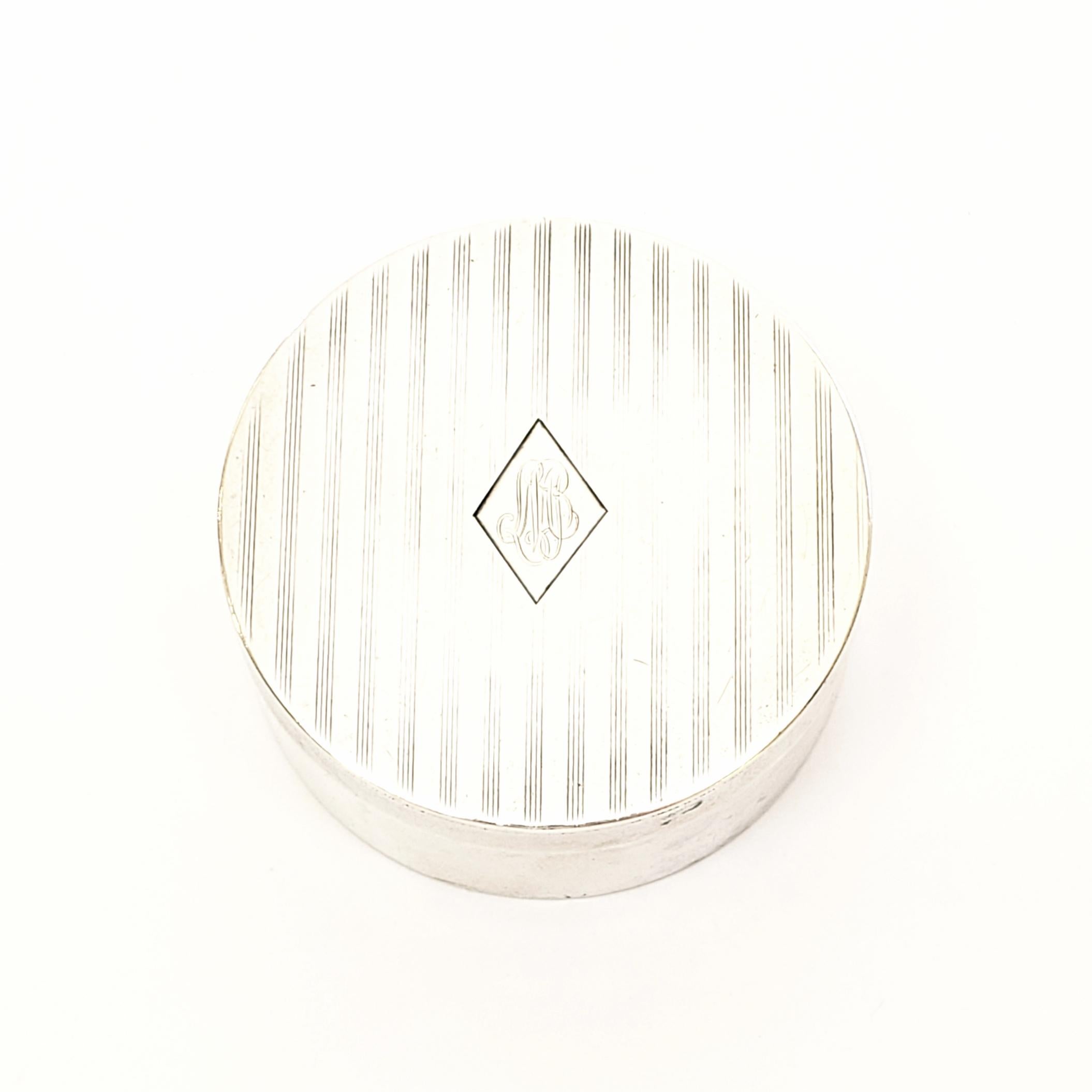 Antique sterling silver pill box by William B Kerr of Newark, NJ.

Beautiful small round box featuring etched lines and a monogram inside a diamond.

Monogram appears to be SMB.

Box measures approximate 1 13/16