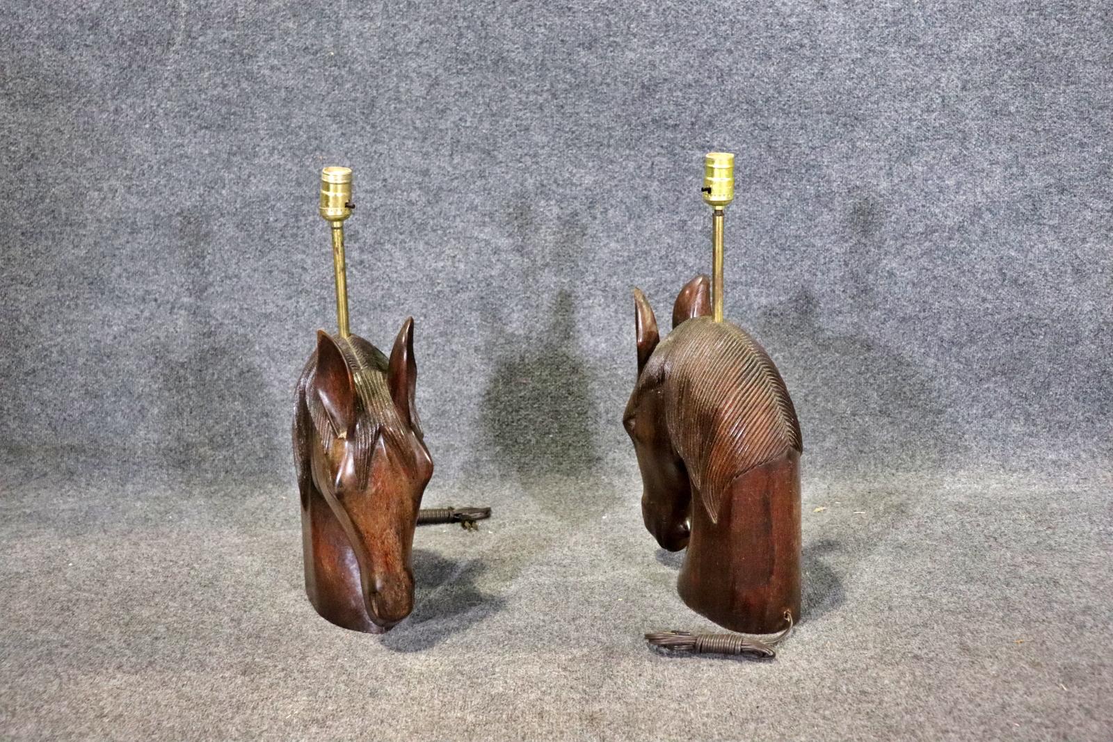 Pair of highly carved table lamps by William Billy Haines. Each horse head is sculpted with hand carved hair and single bulb.
Please confirm location NY or NJ