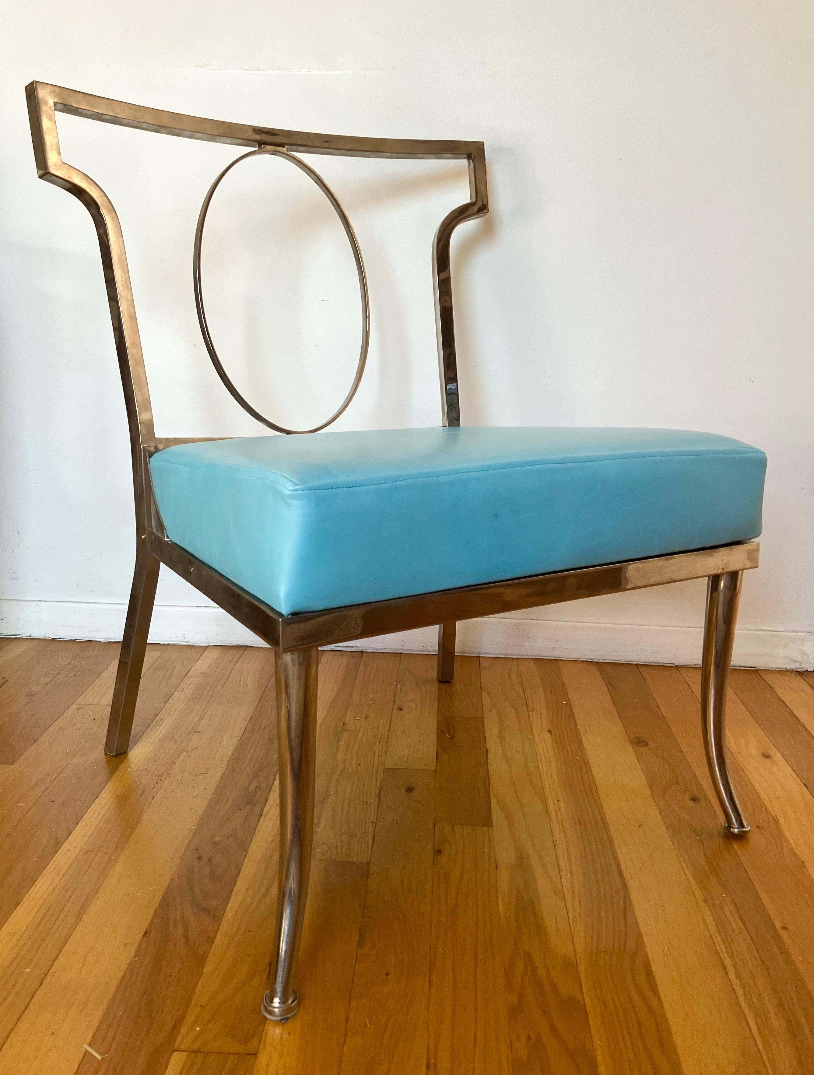 Sexy boudoir slipper chair with crisp tailored profile. Square brass tube is elegantly shaped into post-modern classical form. This example is unusual due to its chromed finish. Later blue leather seat.