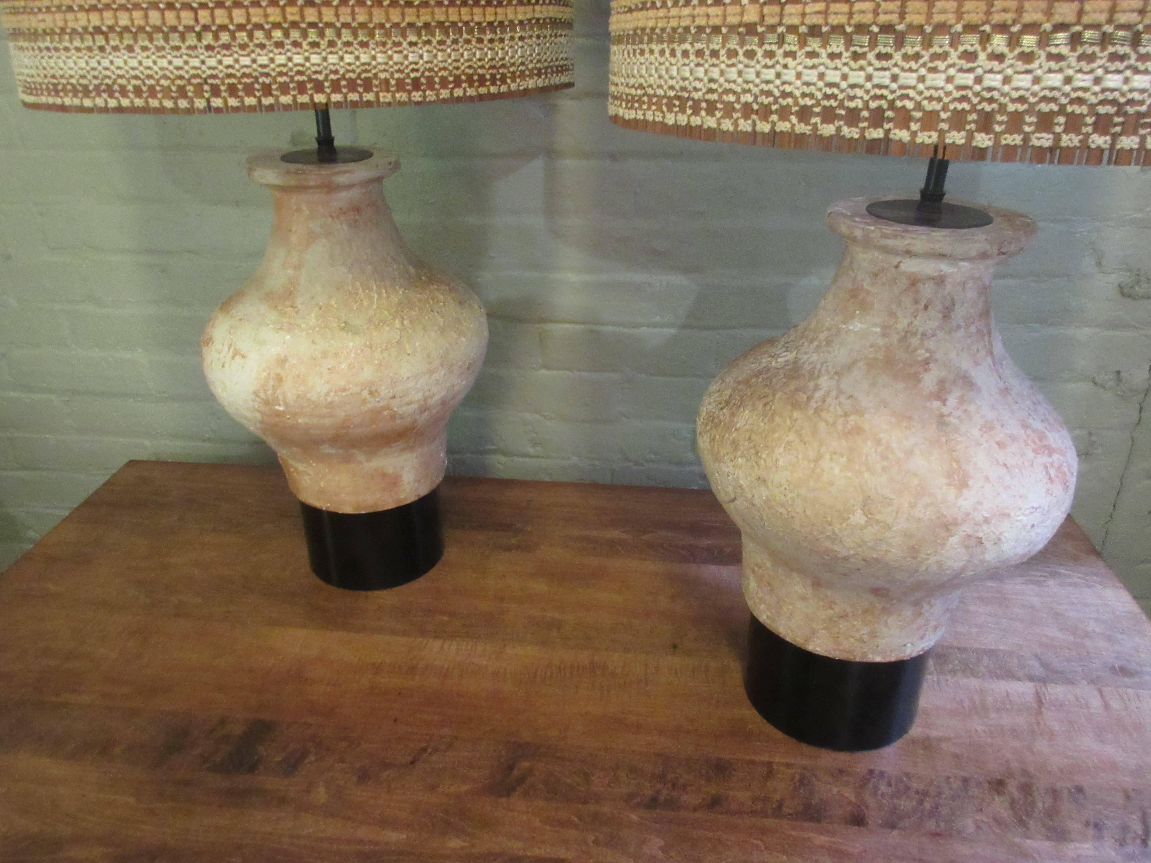 William Billy Haines Etuscan style ceramic lamps from the Estate of Dr. Herbert and Rita LeRoy Roedling of Beverly Hills California. Lamps are paired with beautiful near perfect Maria Kipp woven lampshades. Ceramic vessels sit on lacquered black