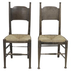 William Birch, retailed by Liberty & Co. Pair of Arts & Crafts oak dining chairs