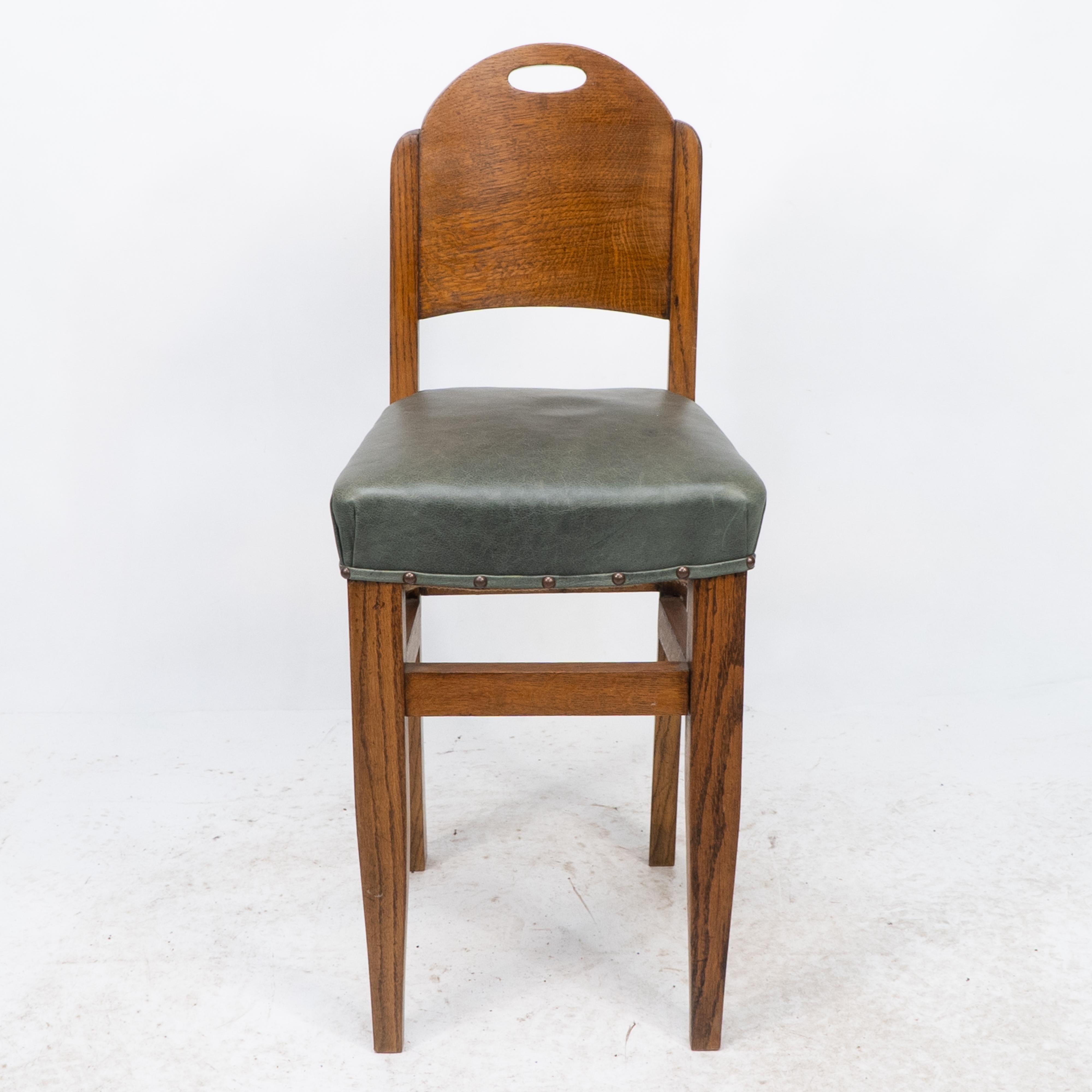 William Birch. A high seat music chair with upper decorative pierced handle to the back, stood on strong square tapering legs. professionally upholstered in a quality green leather.