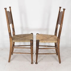William Birch for Liberty & Co. A pair of Arts & Crafts rush seat oak chairs