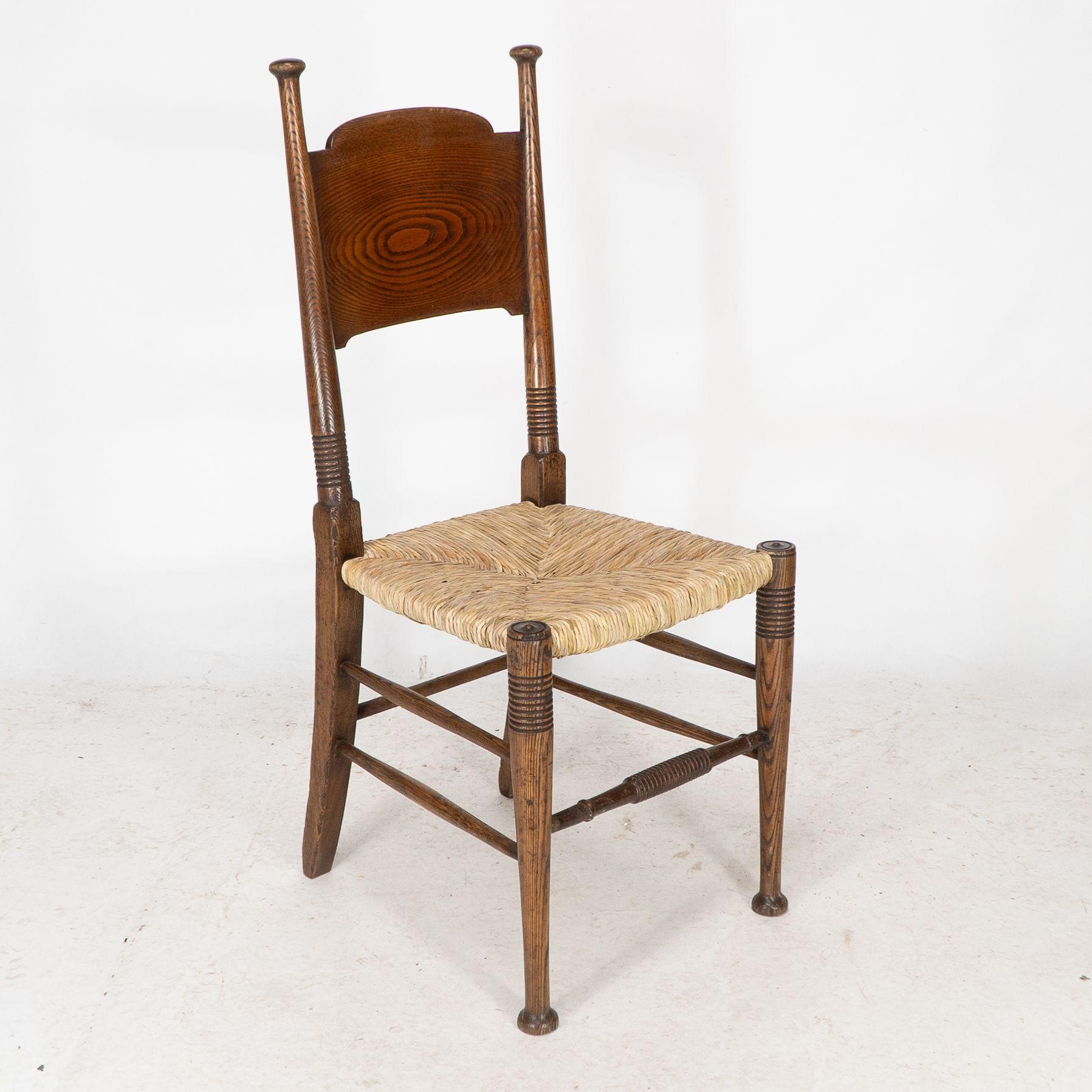 Arts and Crafts William Birch for Liberty & Co. A pair of Arts & Crafts rush seat oak chairs For Sale