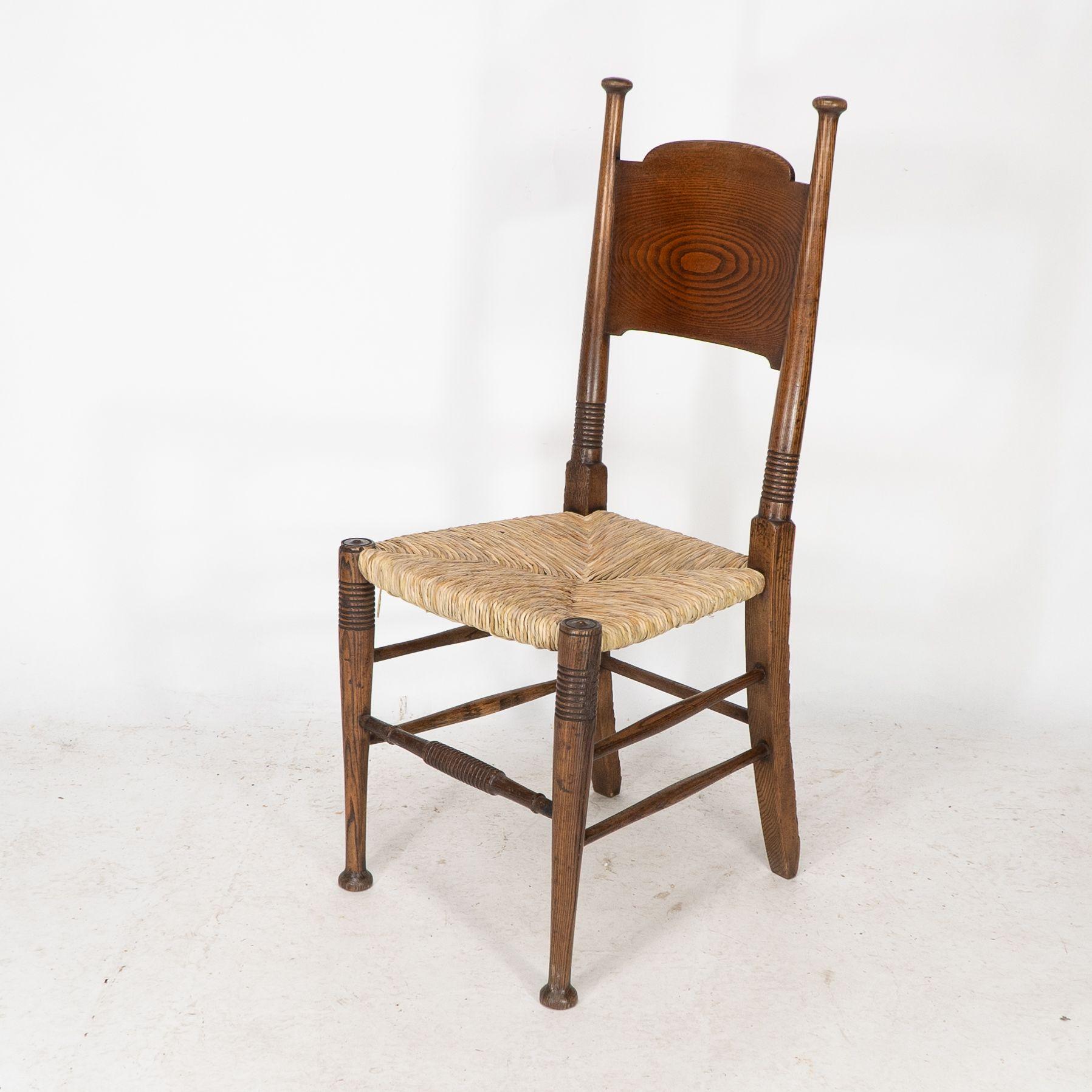 Early 20th Century William Birch for Liberty & Co. A pair of Arts & Crafts rush seat oak chairs For Sale