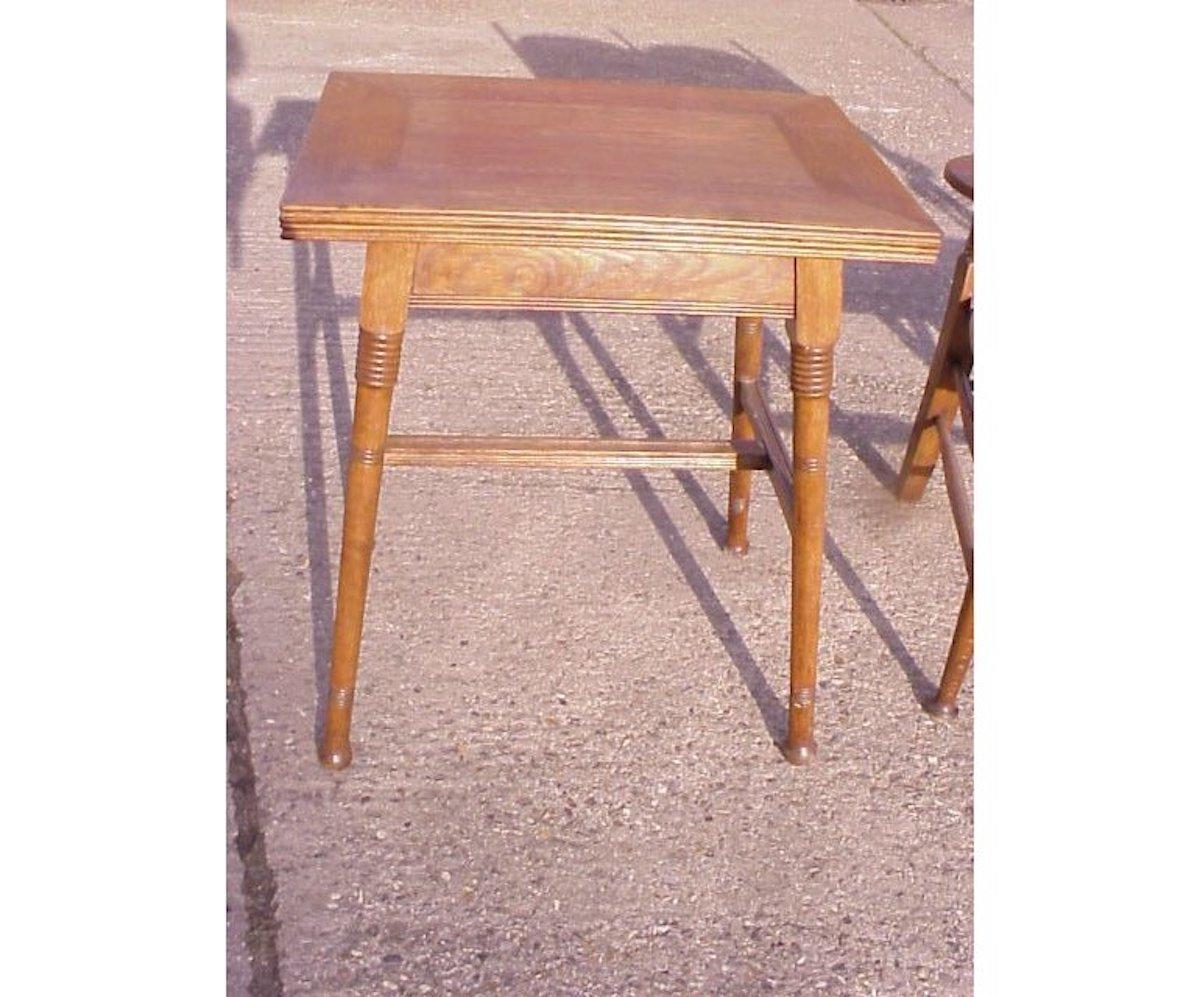 William Birch for Liberty and Co.
A good quality sturdy Arts & Crafts oak fold over card table with precise mitred corners to the top on splayed ring turned legs united by an H-stretcher. The fold over top opens to reveal storage for playing cards