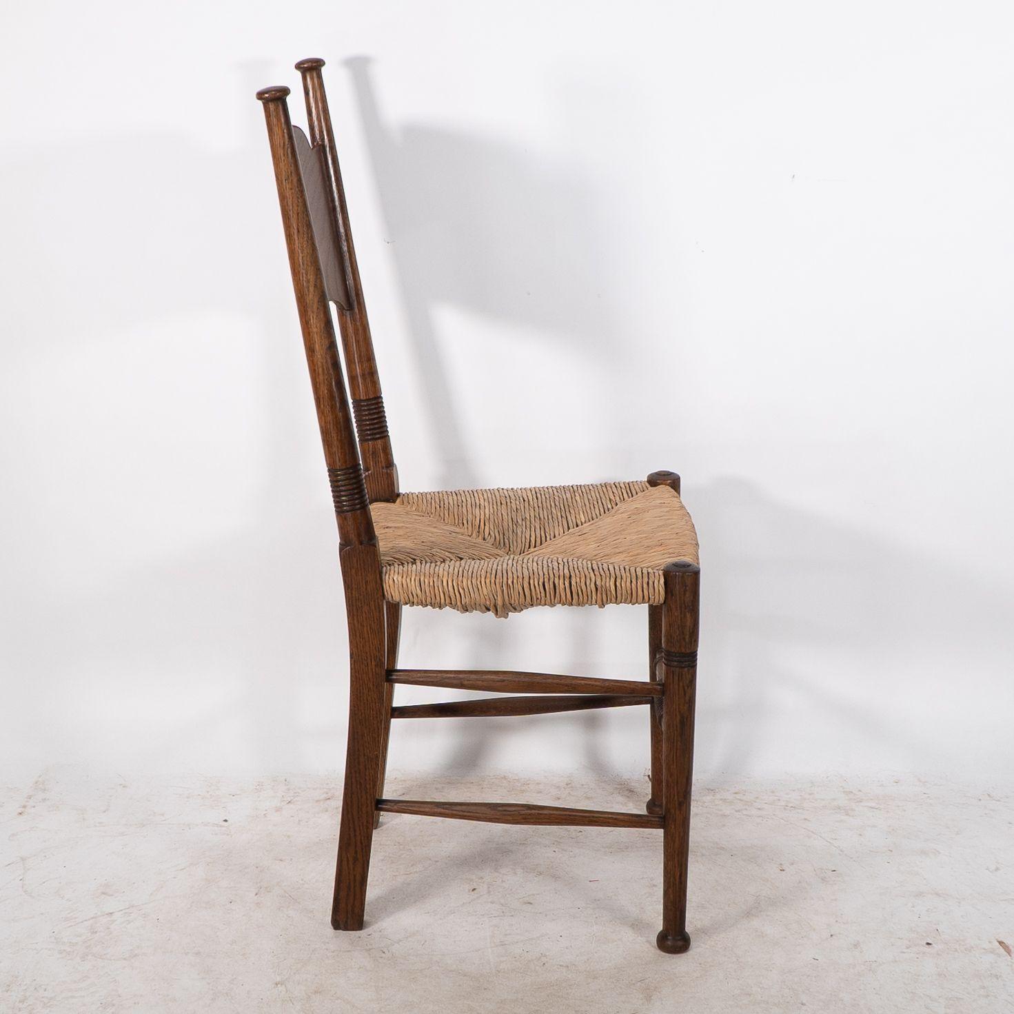 Oak William Birch. Liberty & Co. A Arts and Crafts rush seat oak dining chair For Sale