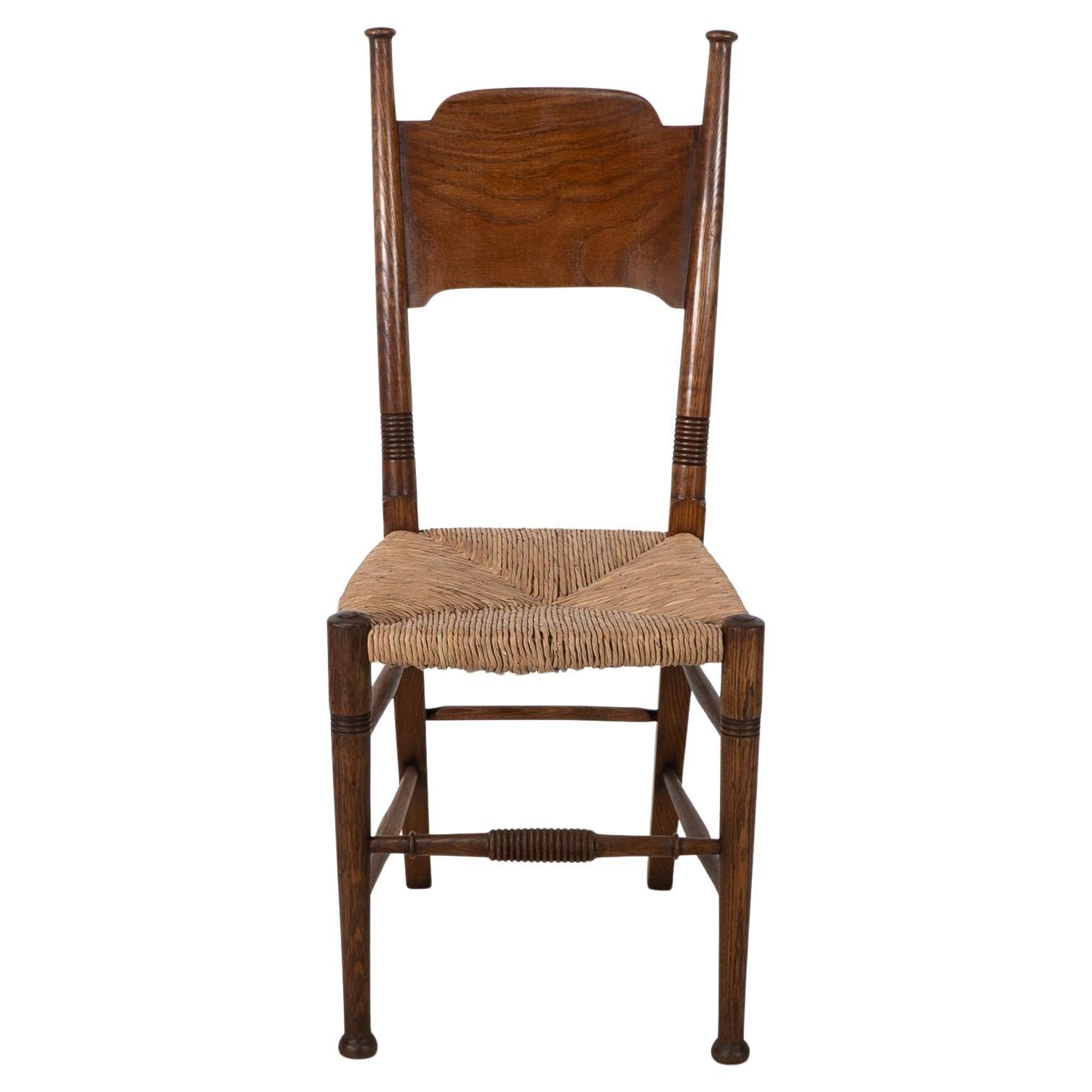 William Birch. Liberty & Co. A Arts and Crafts rush seat oak dining chair
