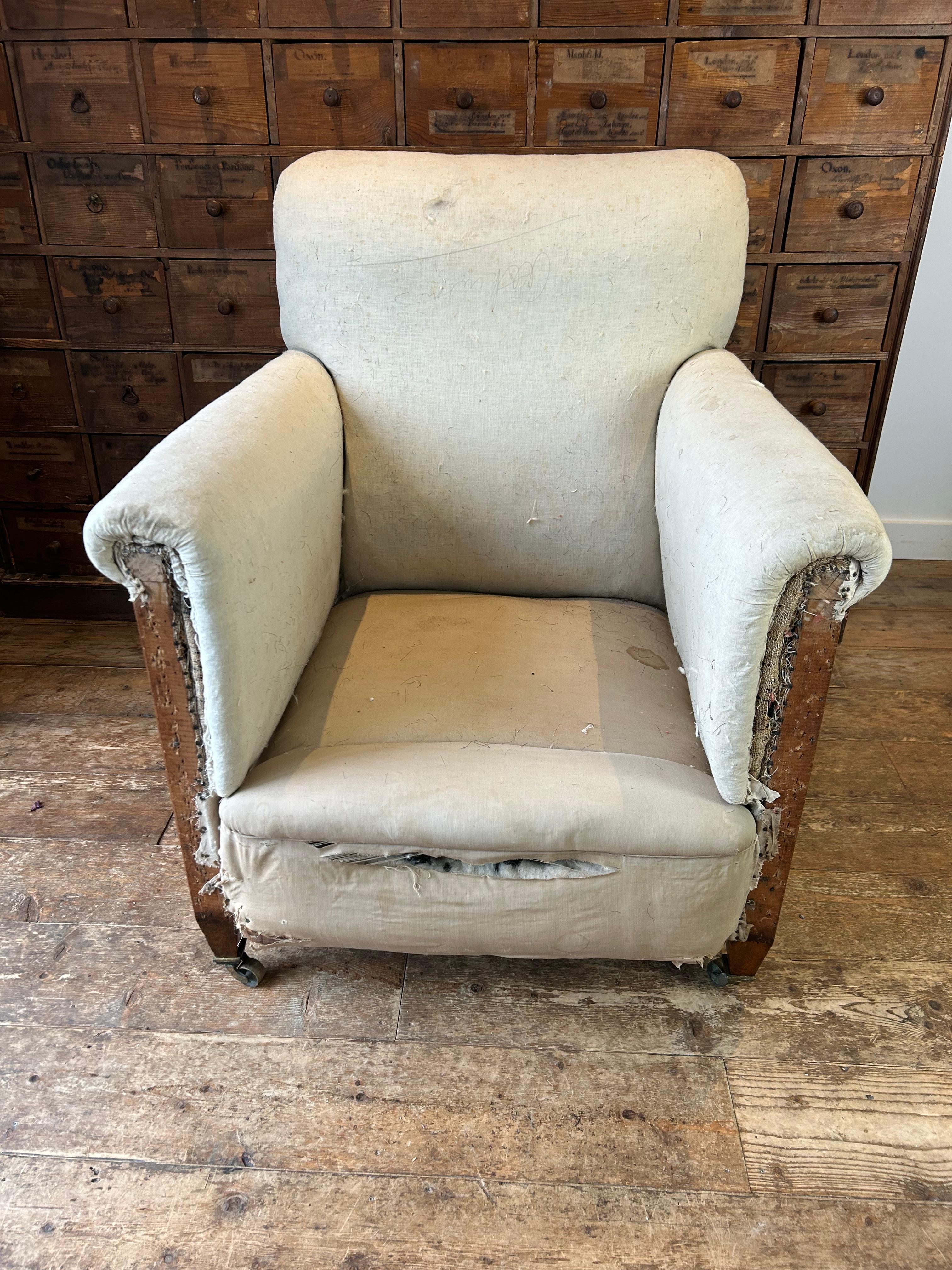 A large scale country house English armchair, by William Birch. The back leg is stamped W.B and numbered 3599, there is also a signature on the rear seat calico. This comfortable armchair retains its original upholstery in the calico on the arms and