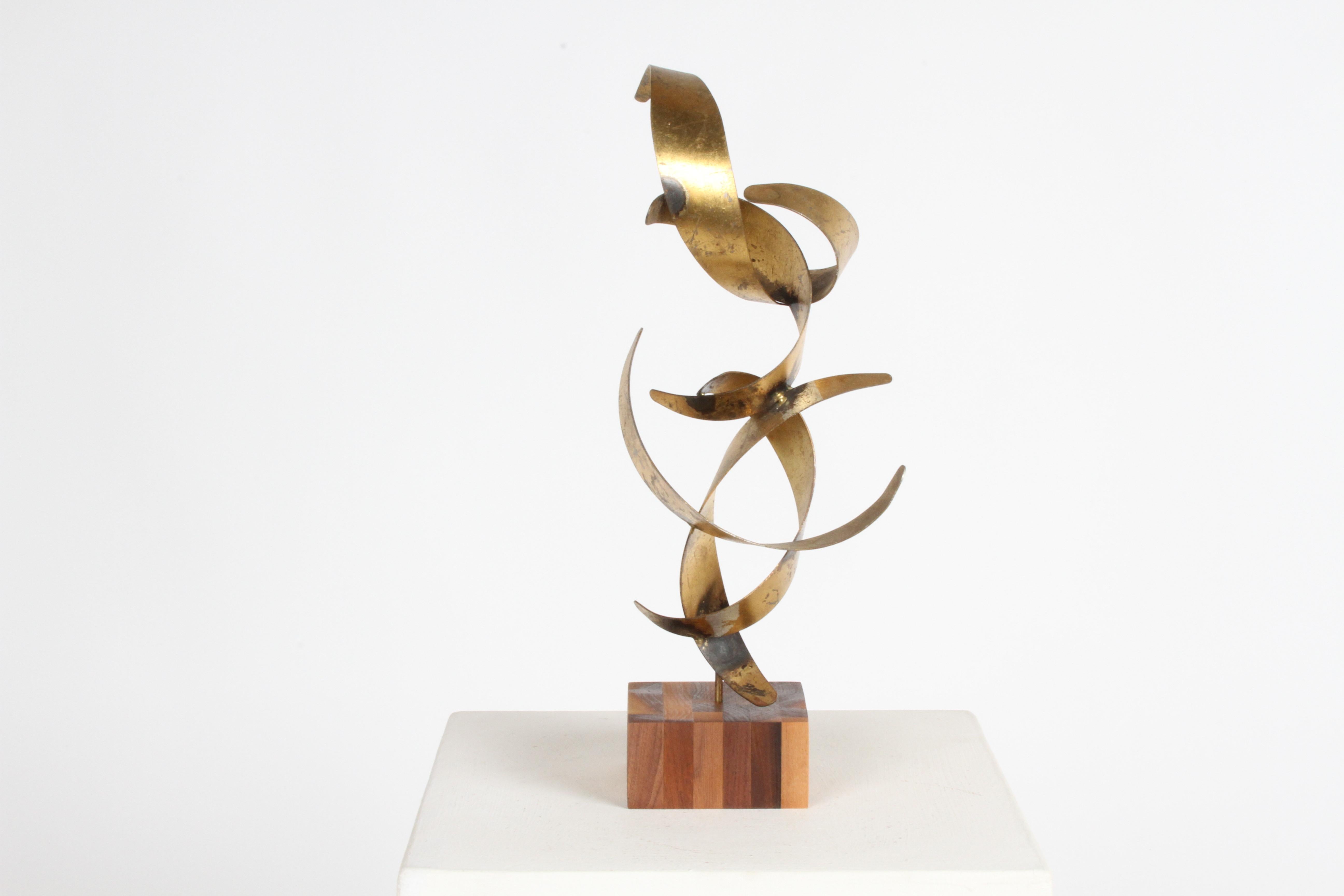 Signed William Bowie welded spire abstract metal gilded with both gold and silver leaf on teak base, circa 1960. This piece is unusual as most of Bowie's pieces are wall-mounted forms. There are a few losses to the leafing, but nothing that would