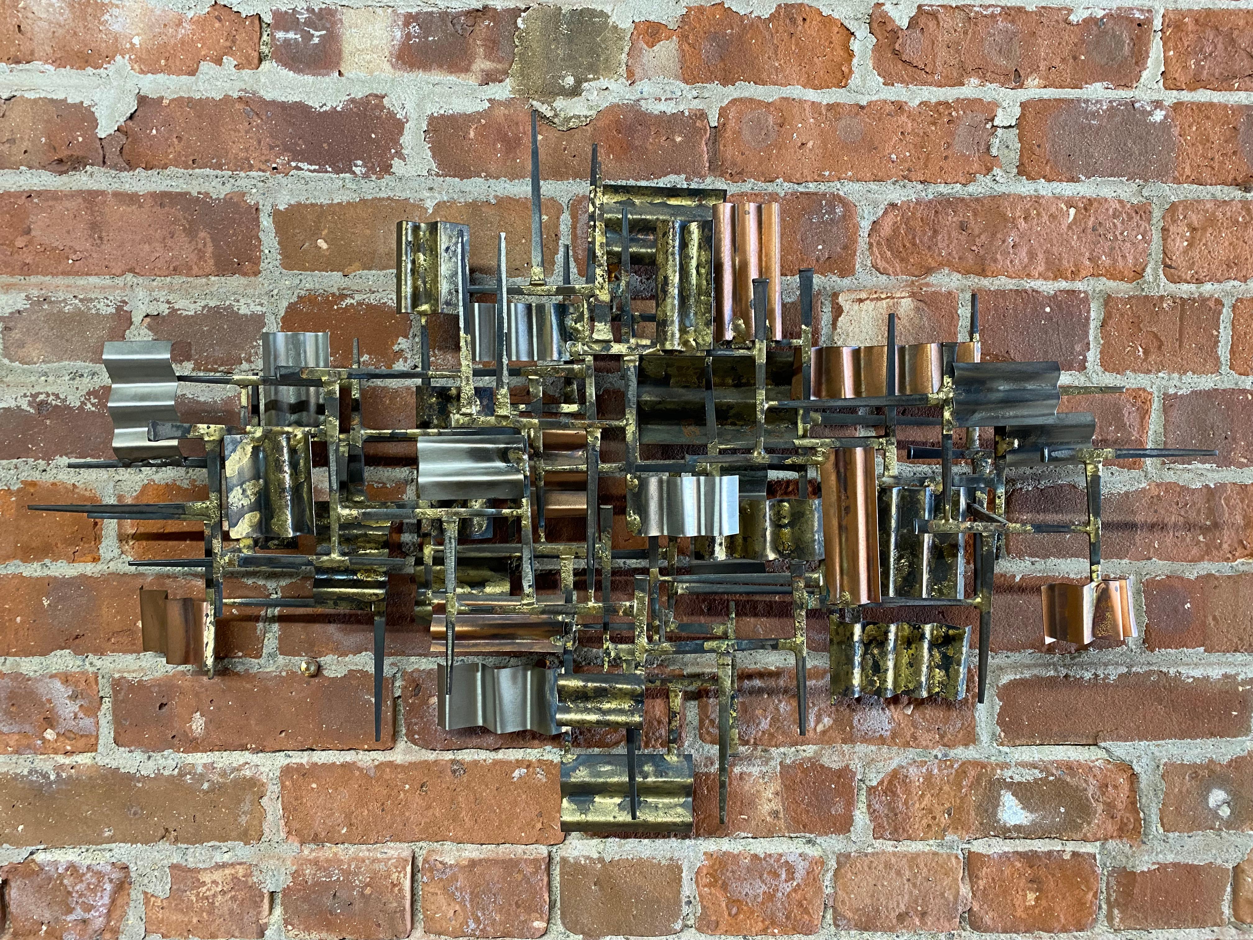 William Bowie square headed nail and mixed metals Brutalist wall sculpture. Circa 1965-70. Complex tiered planes of gilt, welded and crimped mixed metals.William Bowie square headed nail and mixed metals Brutalist wall sculpture. Circa 1965-70.