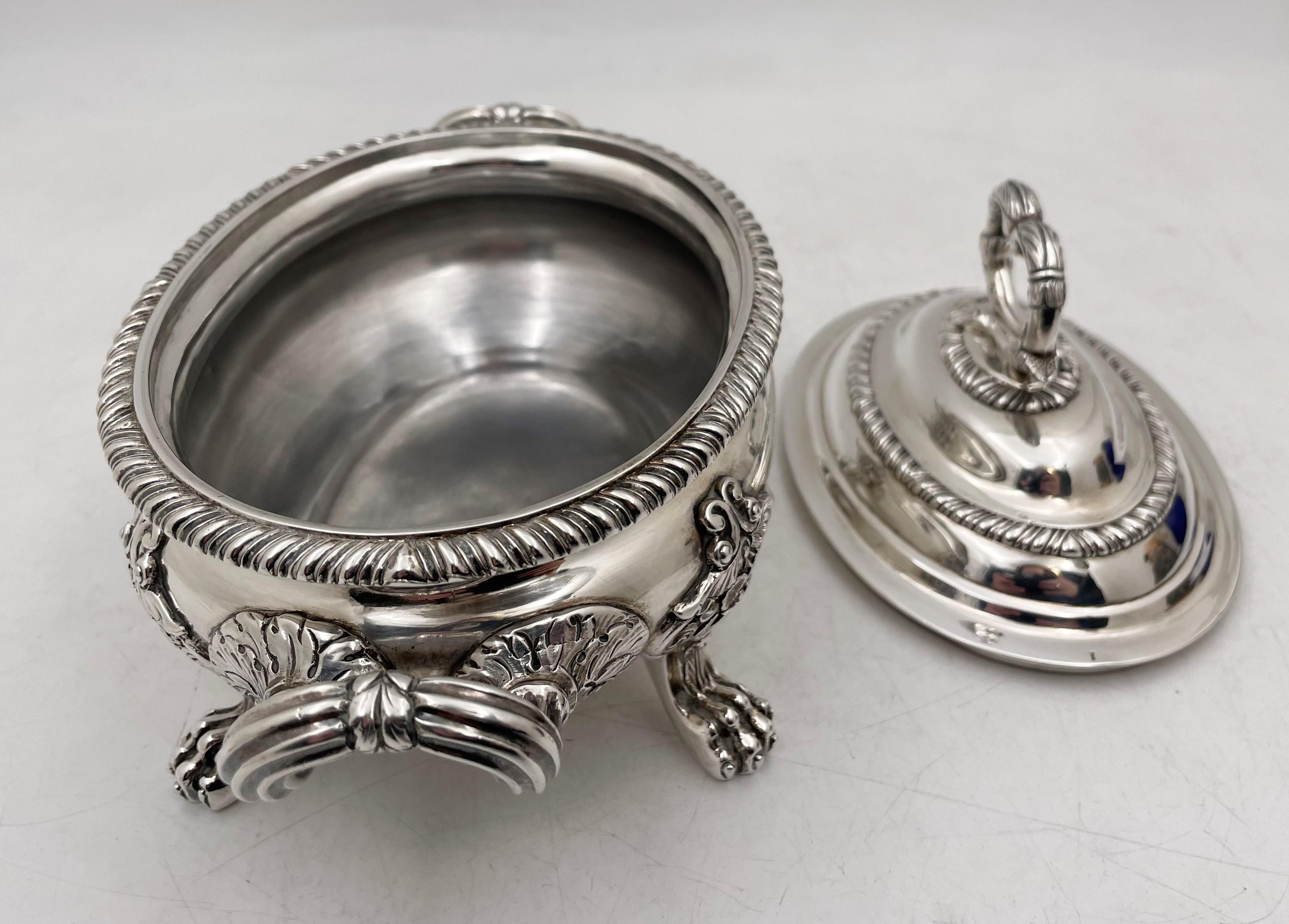 William brown, English sterling silver tureen or covered bowl from 1824 in Georgian style, with a heavy gage, standing on 4 legs realistically modeled after lion's claws, showcasing exquisite, stylized motifs. It measures 8 3/8'' from handle to