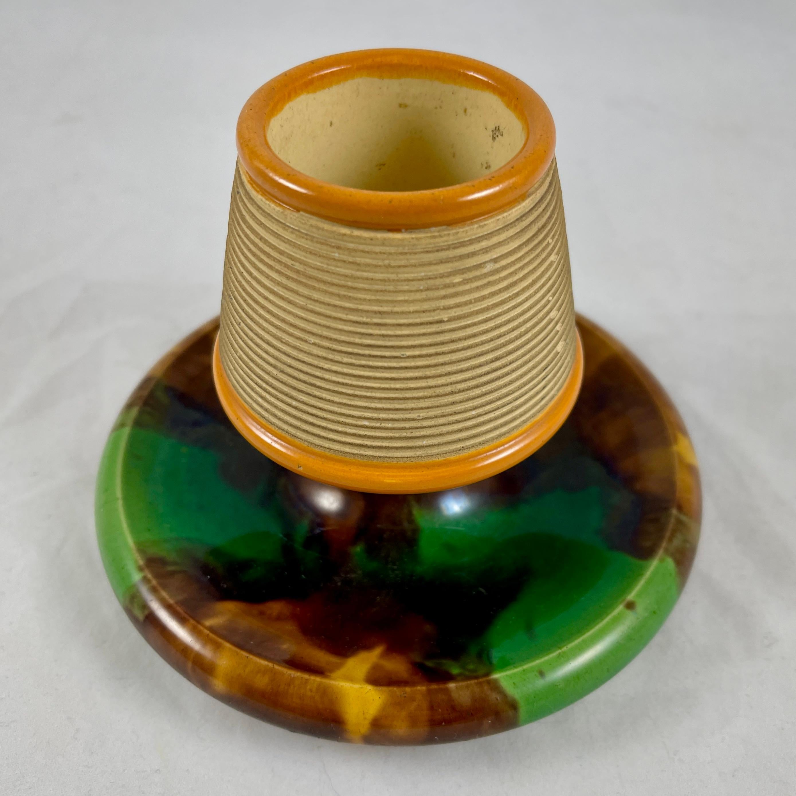 From William Brownfield, Staffordshire, England, a match strike, date marked 8-1877.

A Majolica glazed, earthenware pottery match striker or holder with a green and brown mottled tortoiseshell glazing and yellow ochre rims to the striking