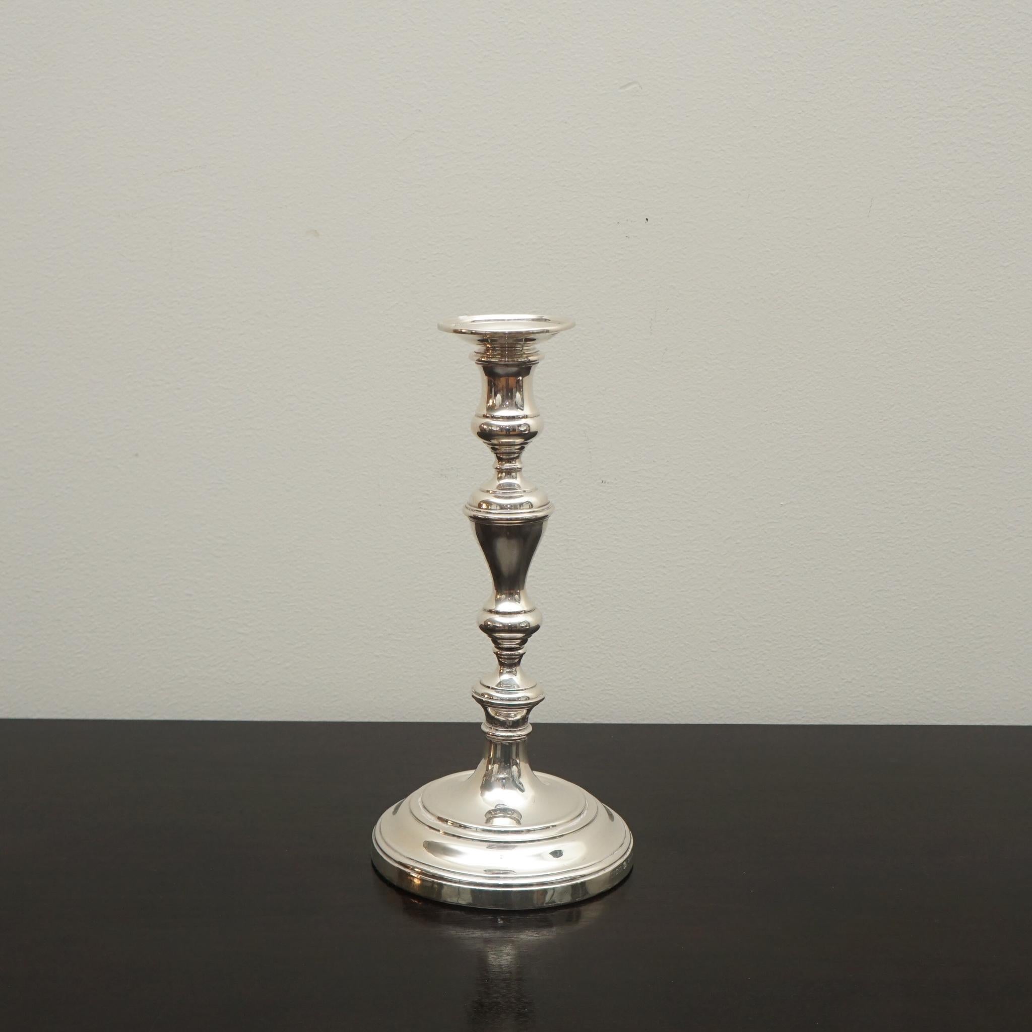 The exquisite pair of silver candlesticks, shown here, were made in London by William Comyns & Sons Ltd, 1934. They both display the impressed manufacturer's mark 'Made in England for Howard & Co. Loaded A9483.'